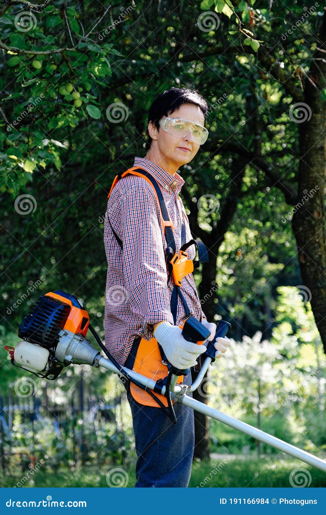 Portrait of Woman Gardener Mowing the Grass on Backyard Using String ...