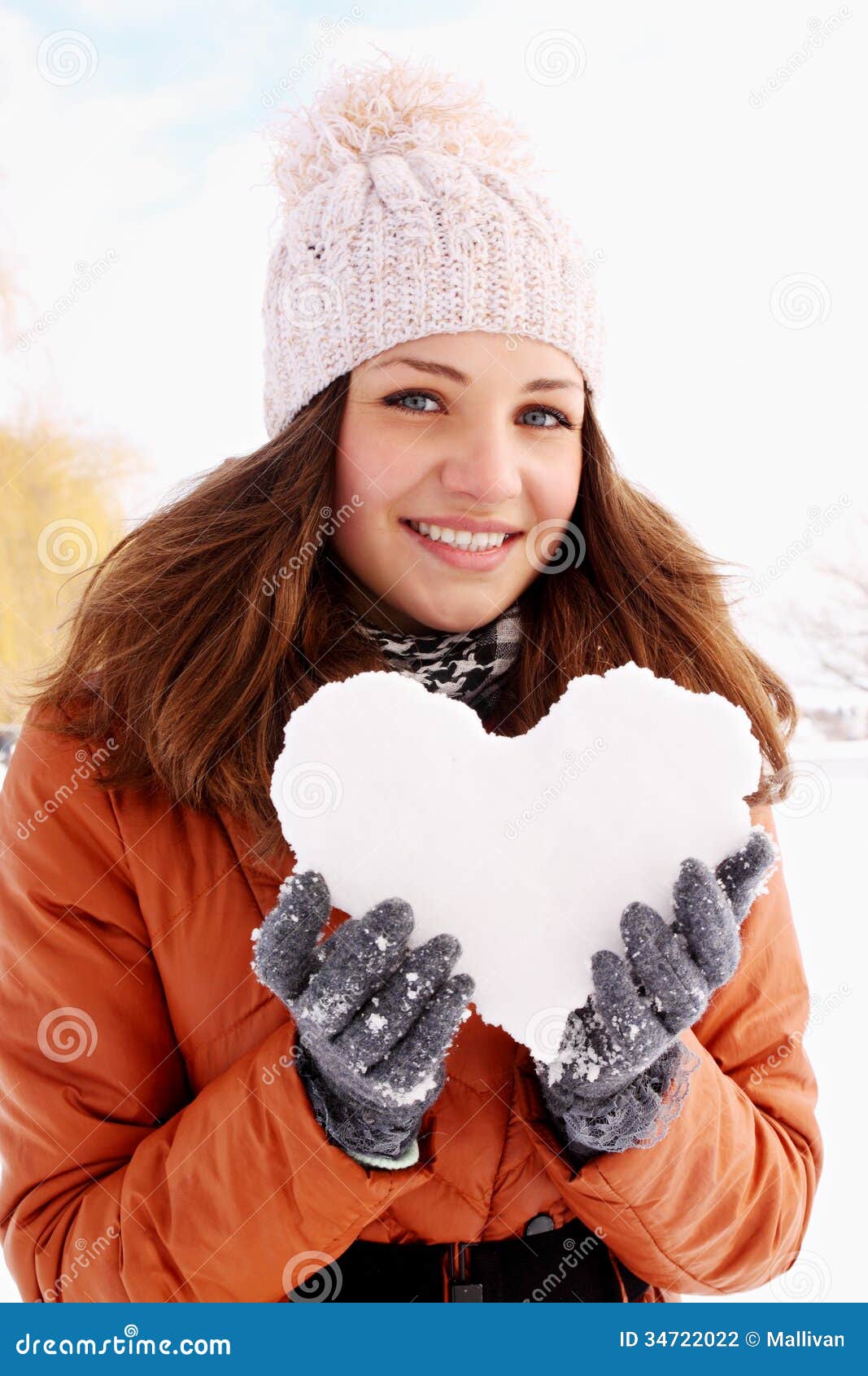 Portrait of a woman with a heart. Woman holds a heart of ice in the hands of