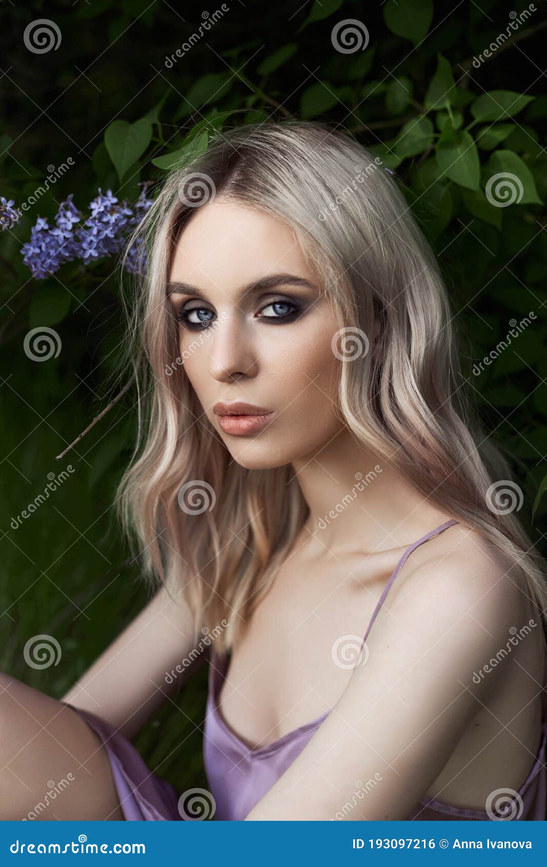 Portrait of a Woman in Lilac Bushes in a Purple Dress. Face of a Girl ...