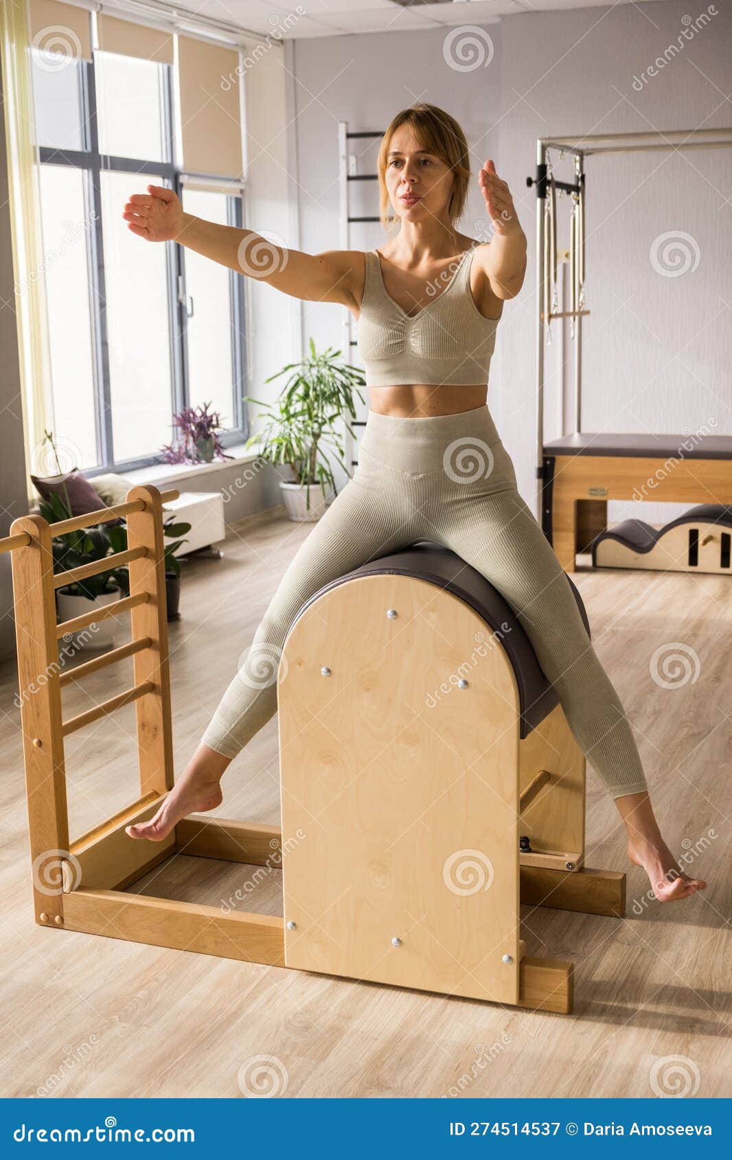 Portrait of Woman Pilates Trainer Doing Exersices on the Ladder