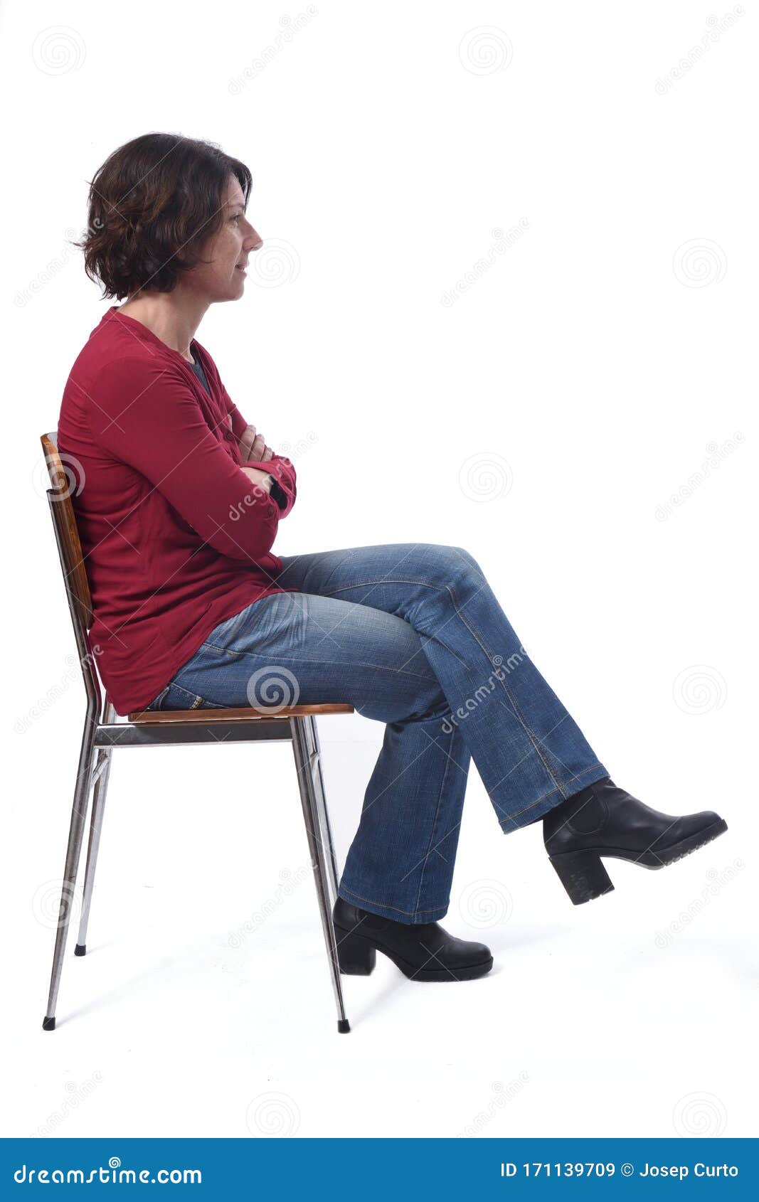 Portrait Of A Woman Sitting On A Chair In White Background