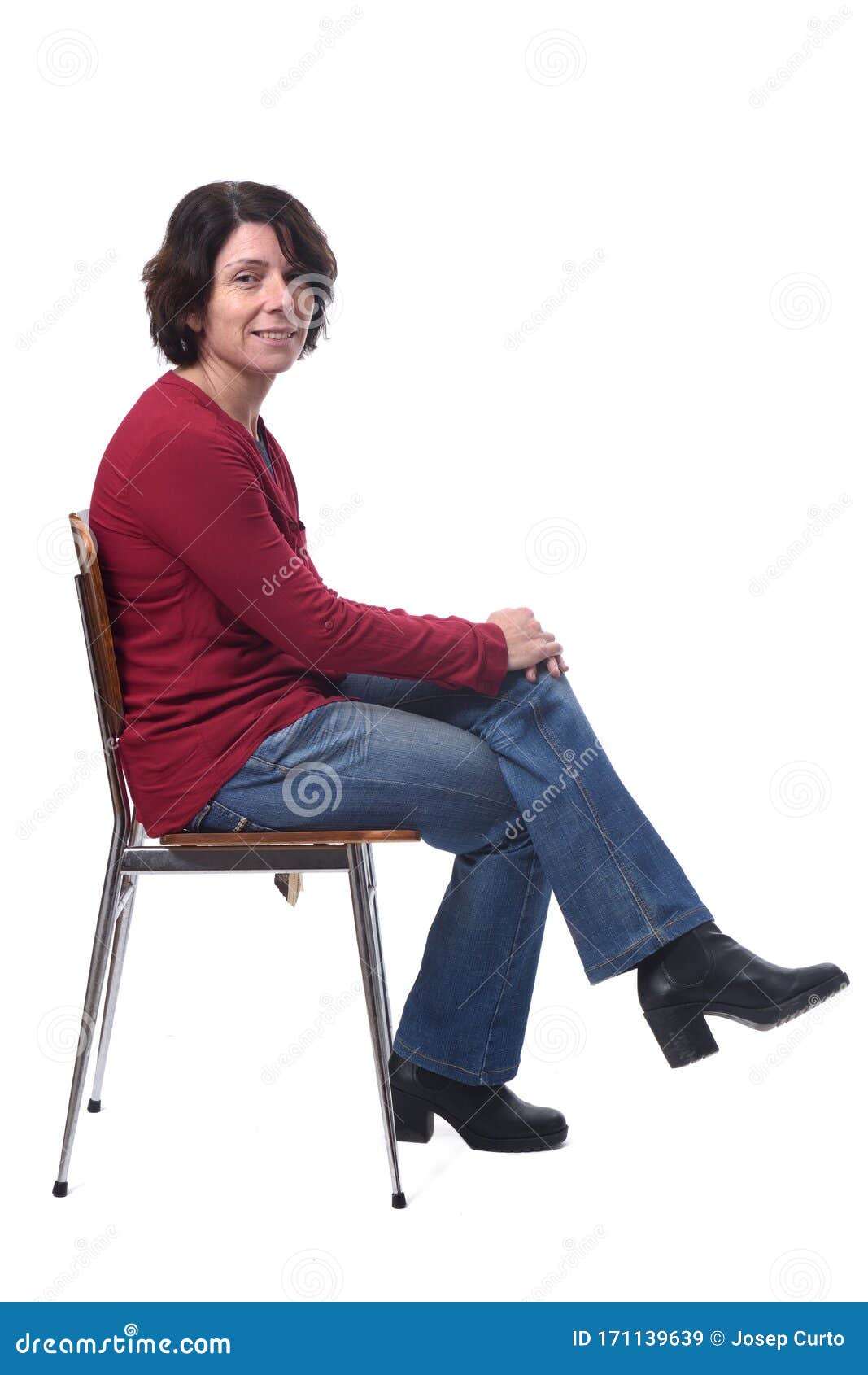 Portrait Of A Woman Sitting On A Chair In White Background