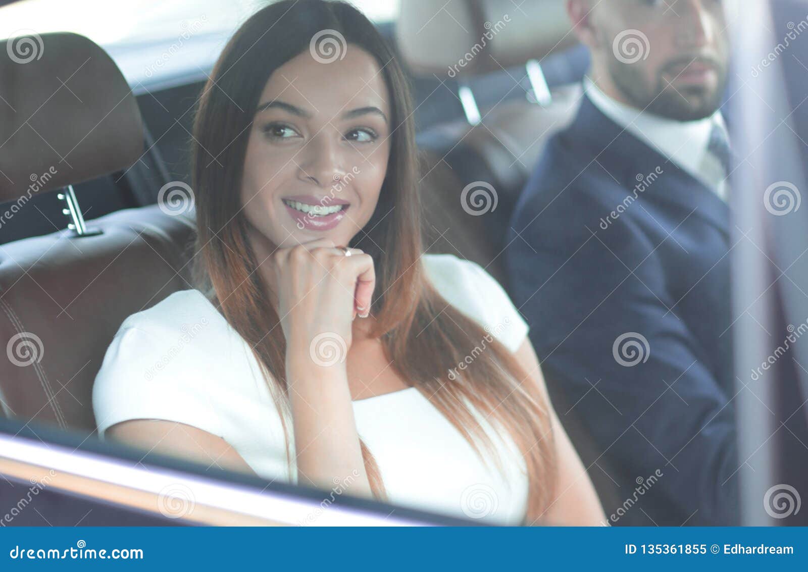 Portrait Of A Woman In A White Dress In Her Car In The Back Seat Stock