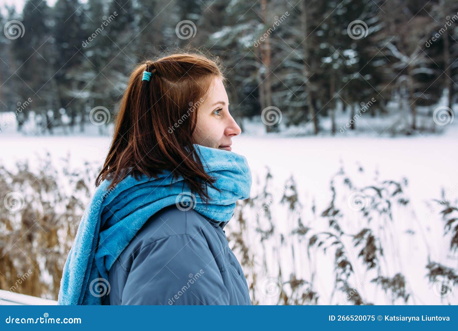 Portrait of Woman in Winter Clothes on the Nature. There is a Lot