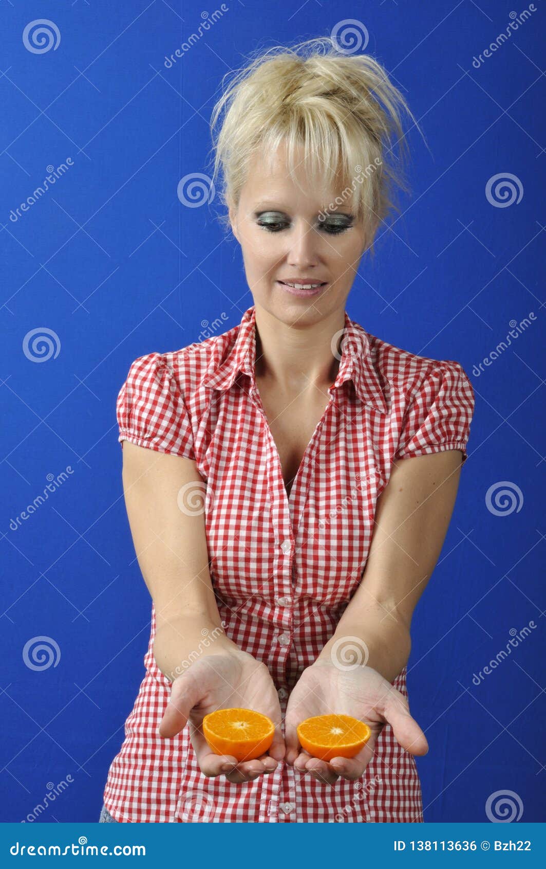 Woman with a clementine stock photo. Image of healthcare 138113636