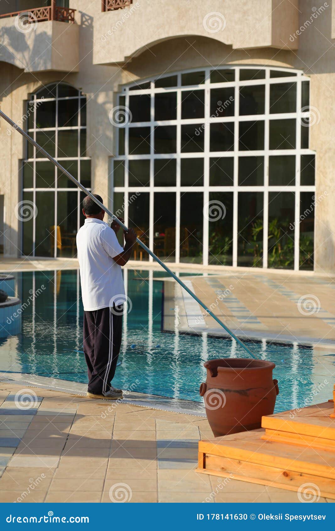 Portrait of a Worker Cleaning the Outdoor Swimming Pool of the Hotel ...