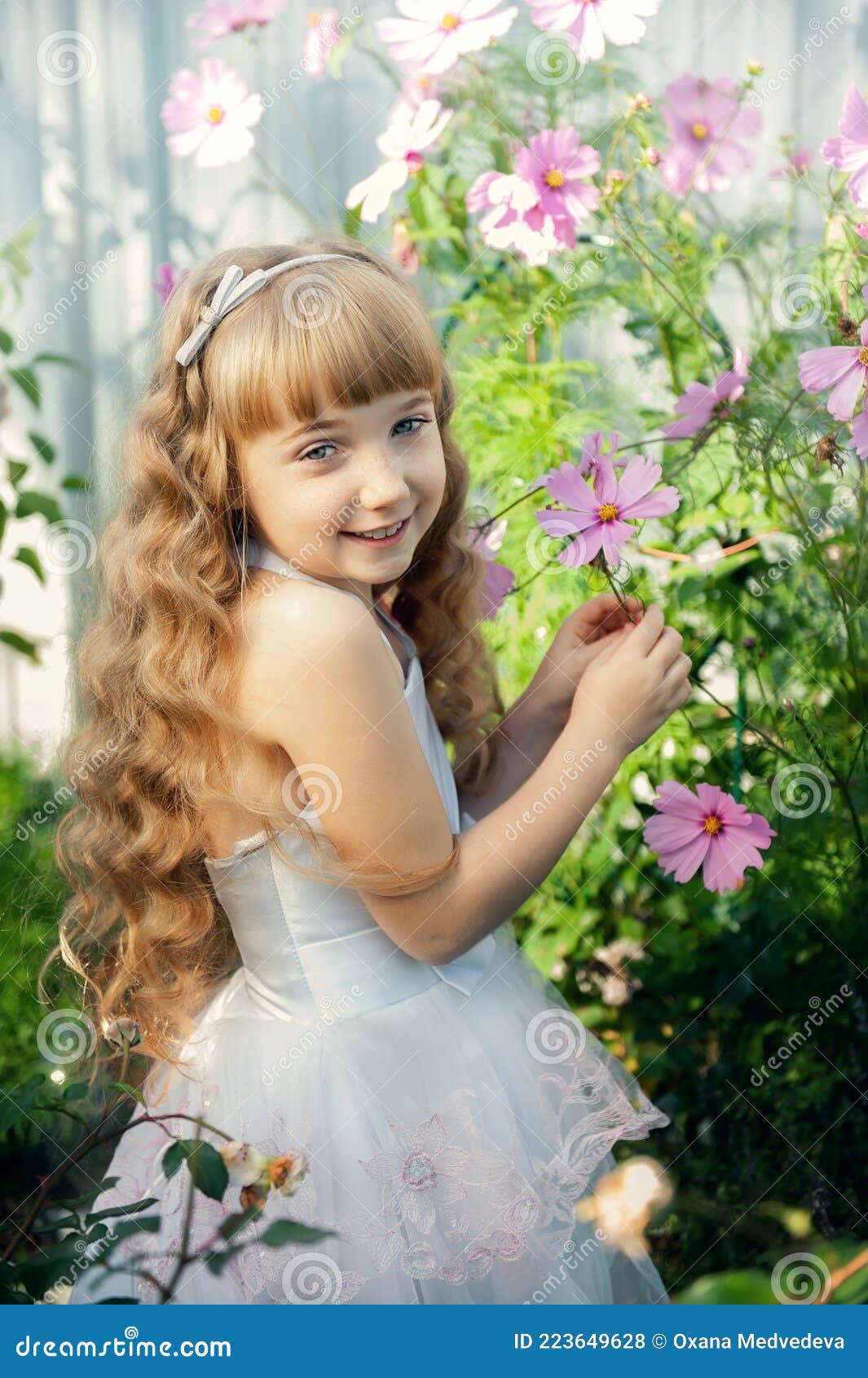 Portrait of a 10-year-old Little Girl in a Blooming Rose Garden ...