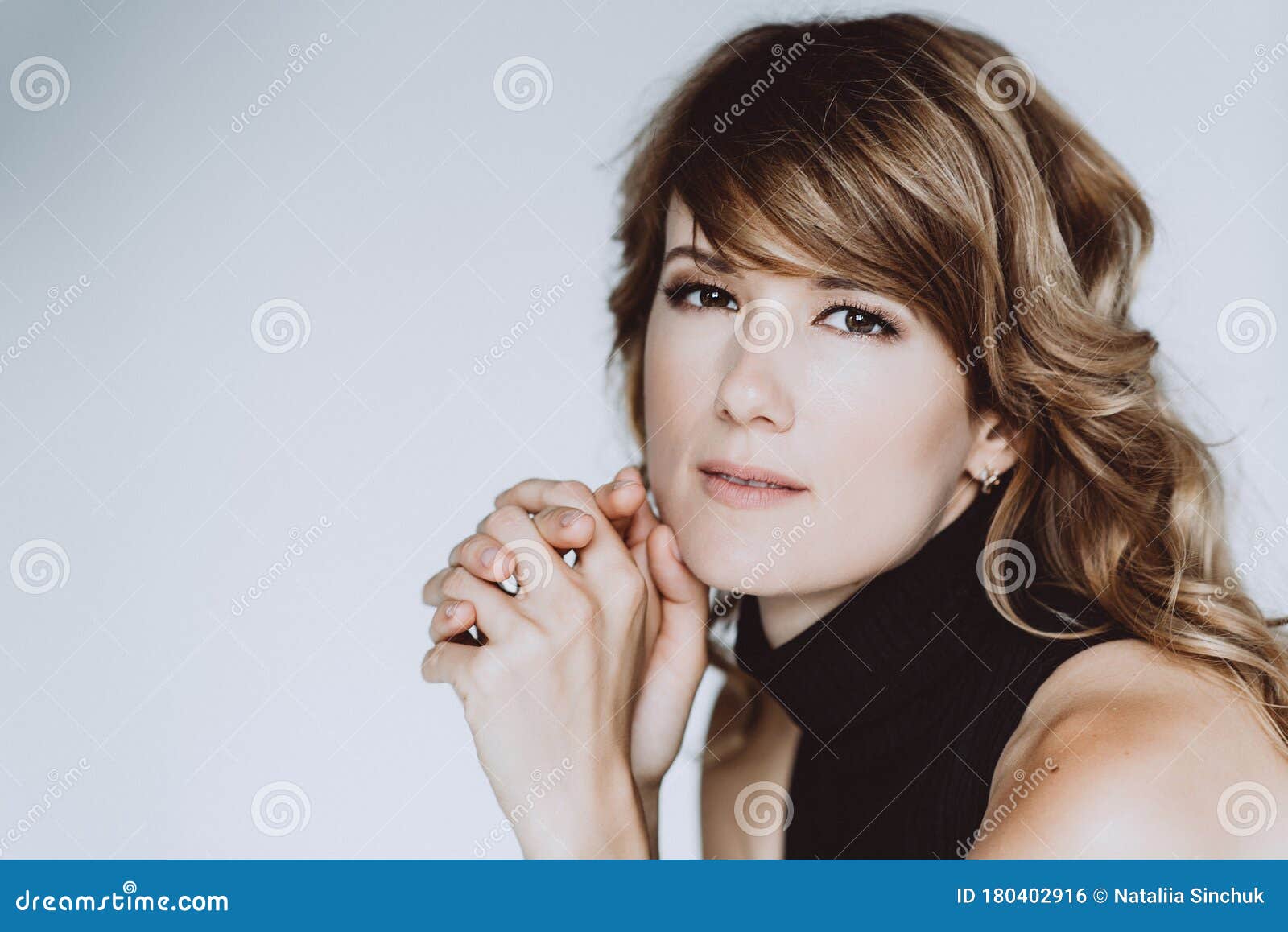Portrait of a 36yearold Woman with Curly Hair and Brown Slanting Eyes