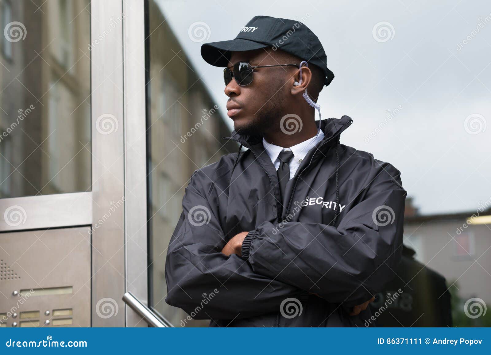 security guard standing arms crossed