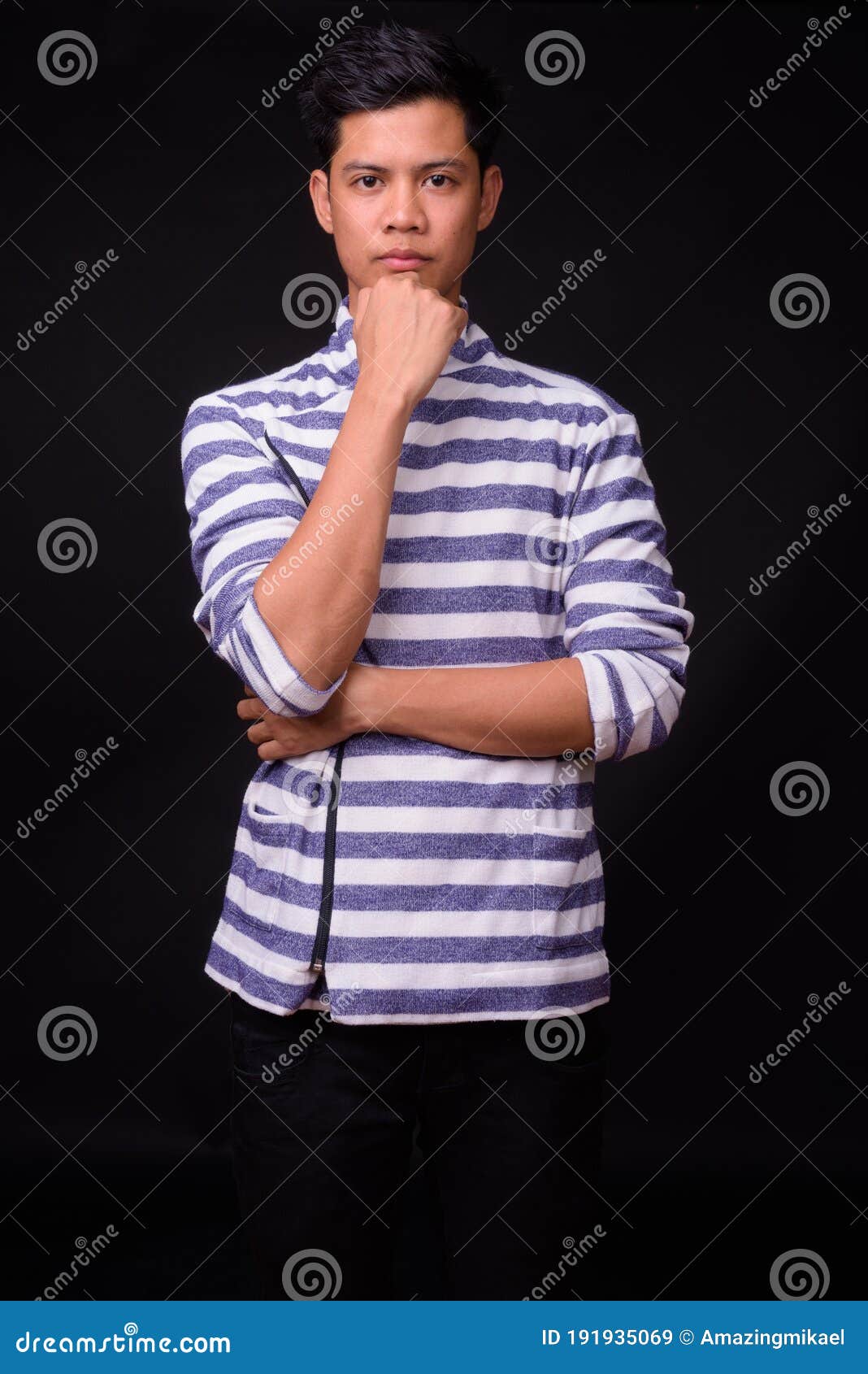 Portrait of Young Asian Man Against Black Background Stock Image ...