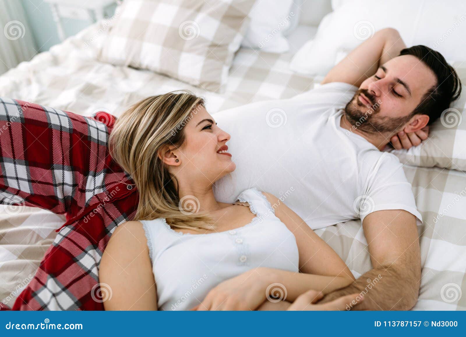 Portrait Of Young Loving Couple In Bedroom Stock I