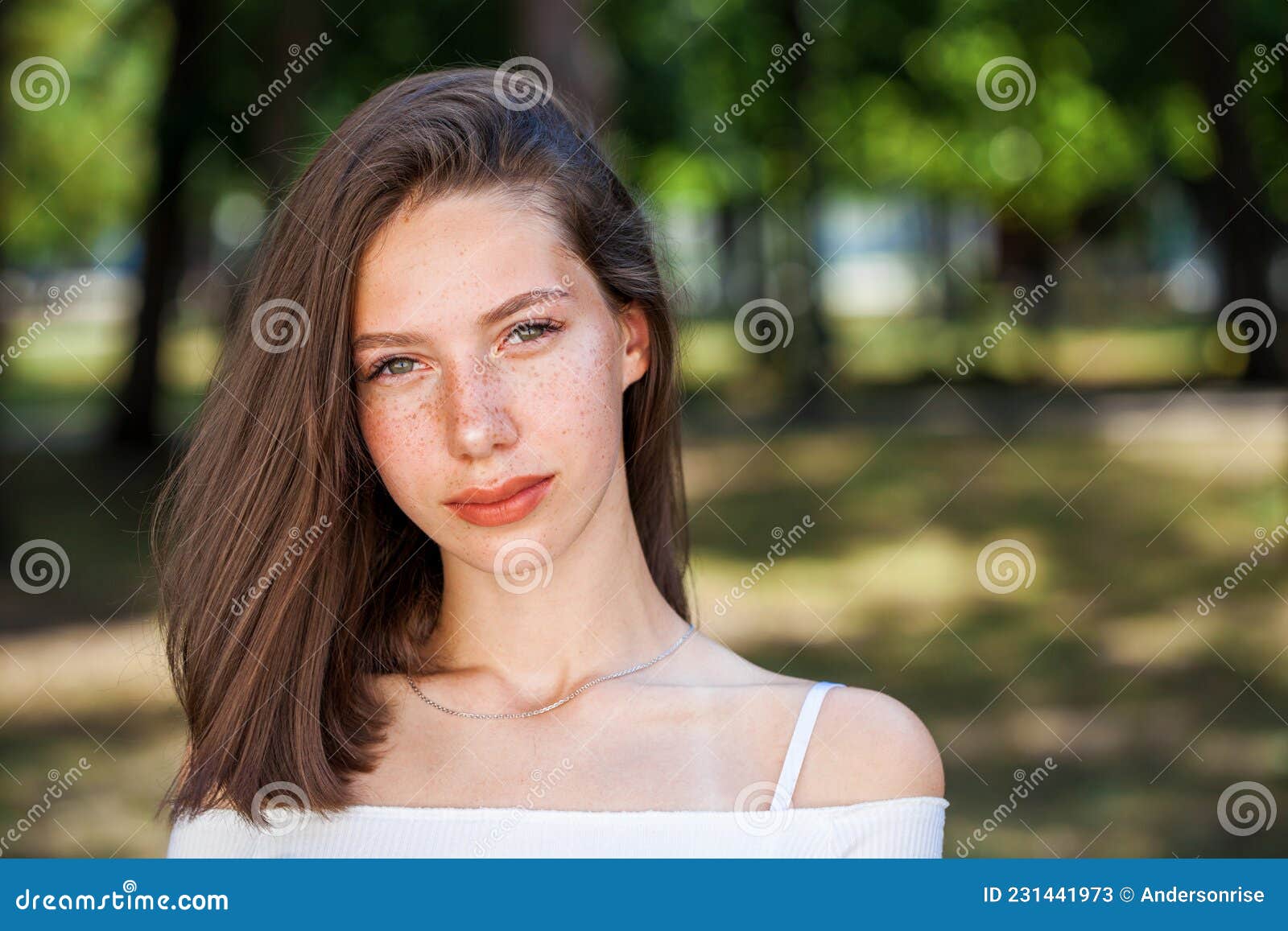 Young Beautiful Brown Haired Girl With Freckles On Her Face Stock Image