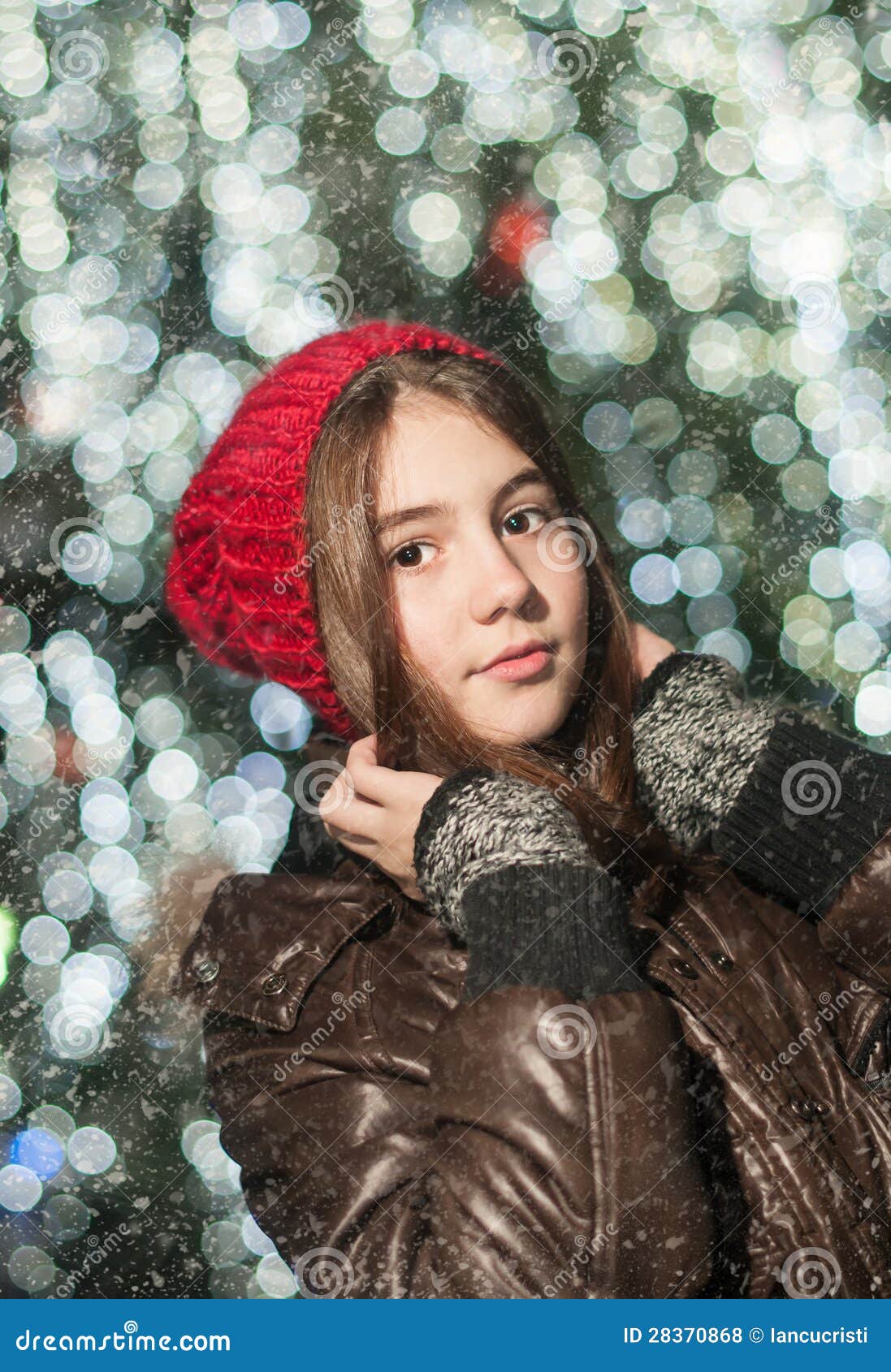 Pretty beautiful young woman in stylish winter glamor clothes goes in a chic  hat in a snowy forest on a winter sunny day. Fashionable attractive stylish  girl. Stock Photo