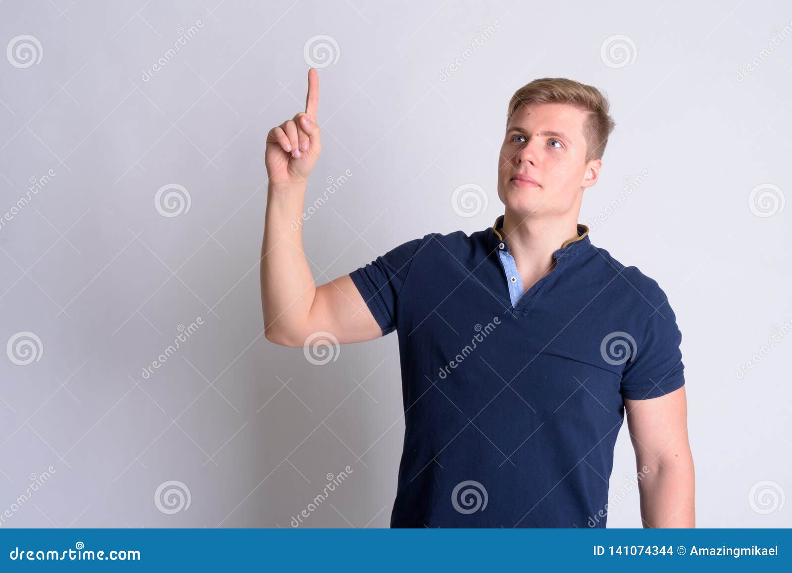 Portrait Of Young Blonde Handsome Man Thinking And Pointing Up Stock ...