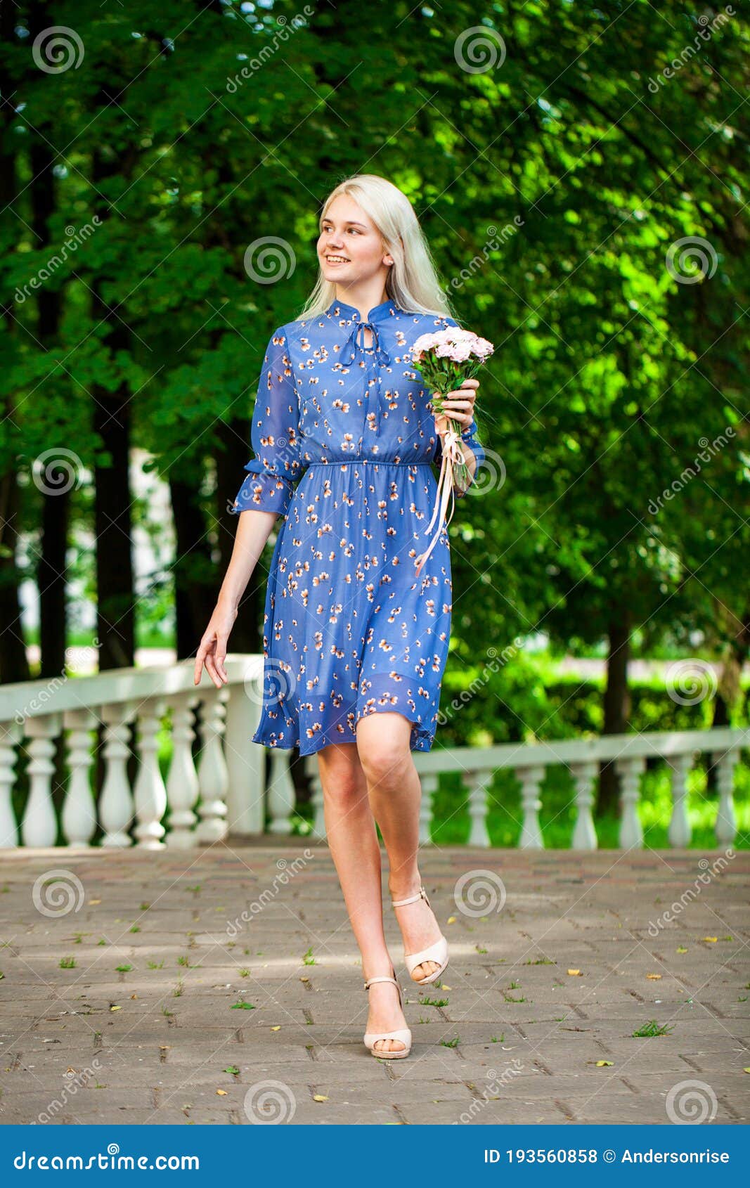 Portrait of a Young Blonde Woman in Blue Dress Walking in Summer ...