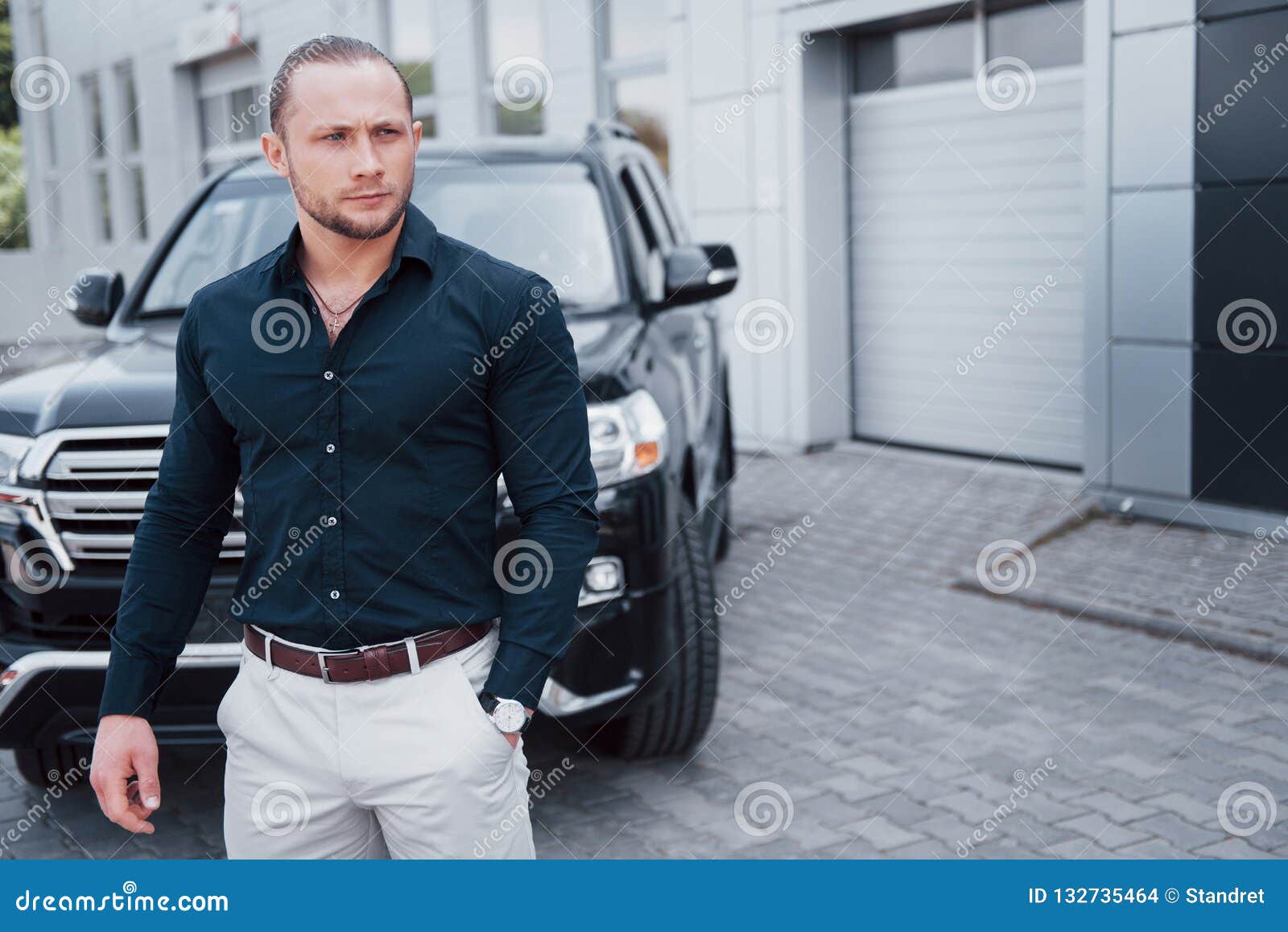 Portrait of a Young Bodyguard Near the Car. he Performs Dangerous Work