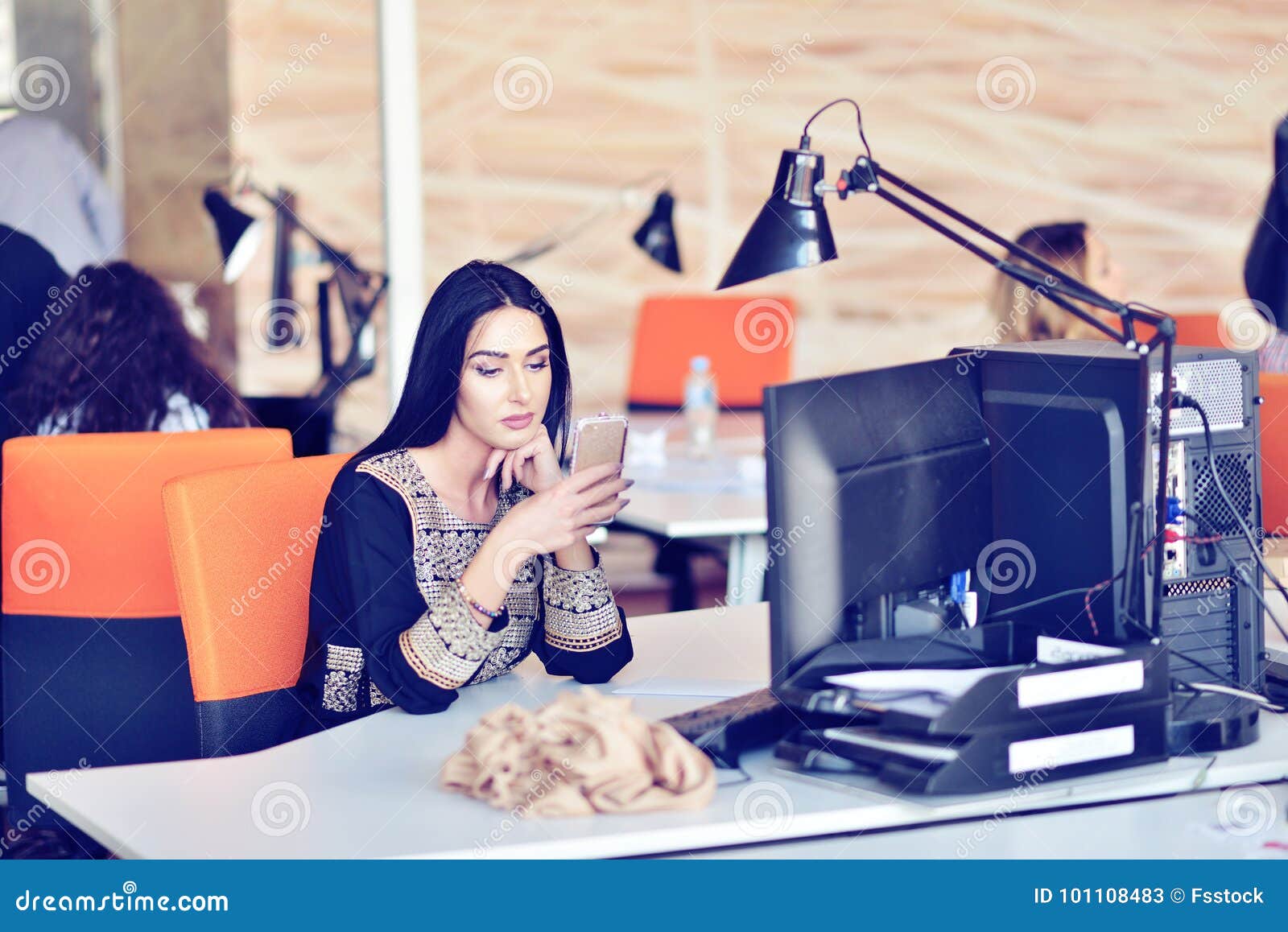 Portrait Of Young Bored Attractive Woman At Office Desk With