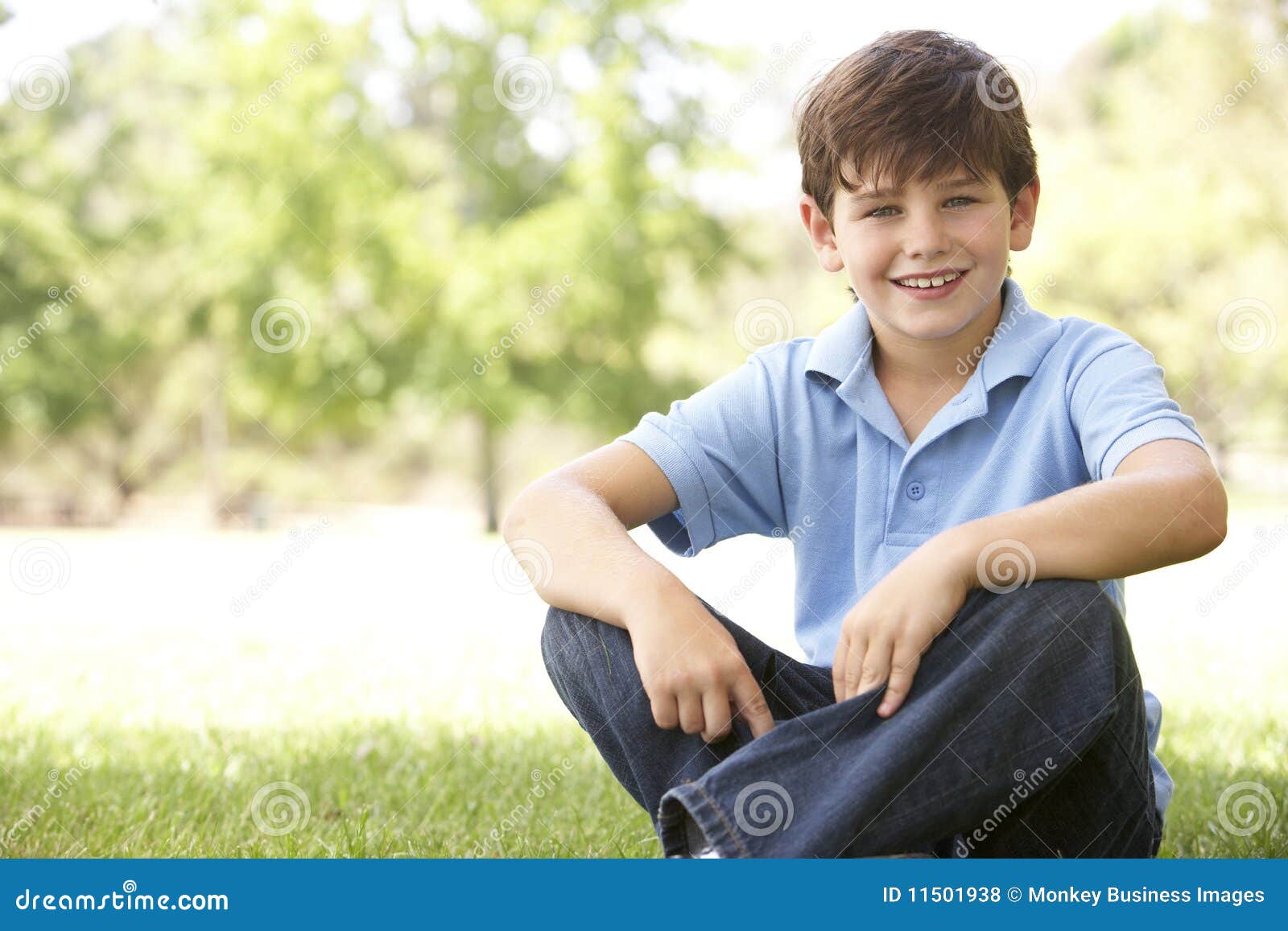Portrait Of Young Boy Sitting In Park Royalty Free Stock Photos - Image ...