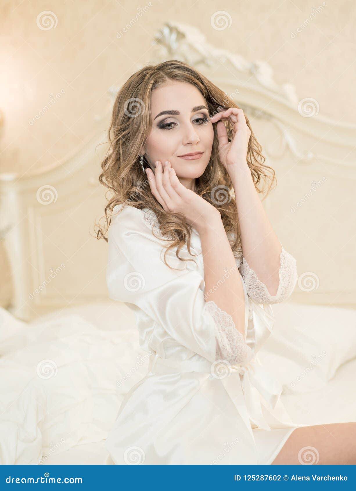 Portrait Of A Young Bride In White Lace Boudoir With Wavy