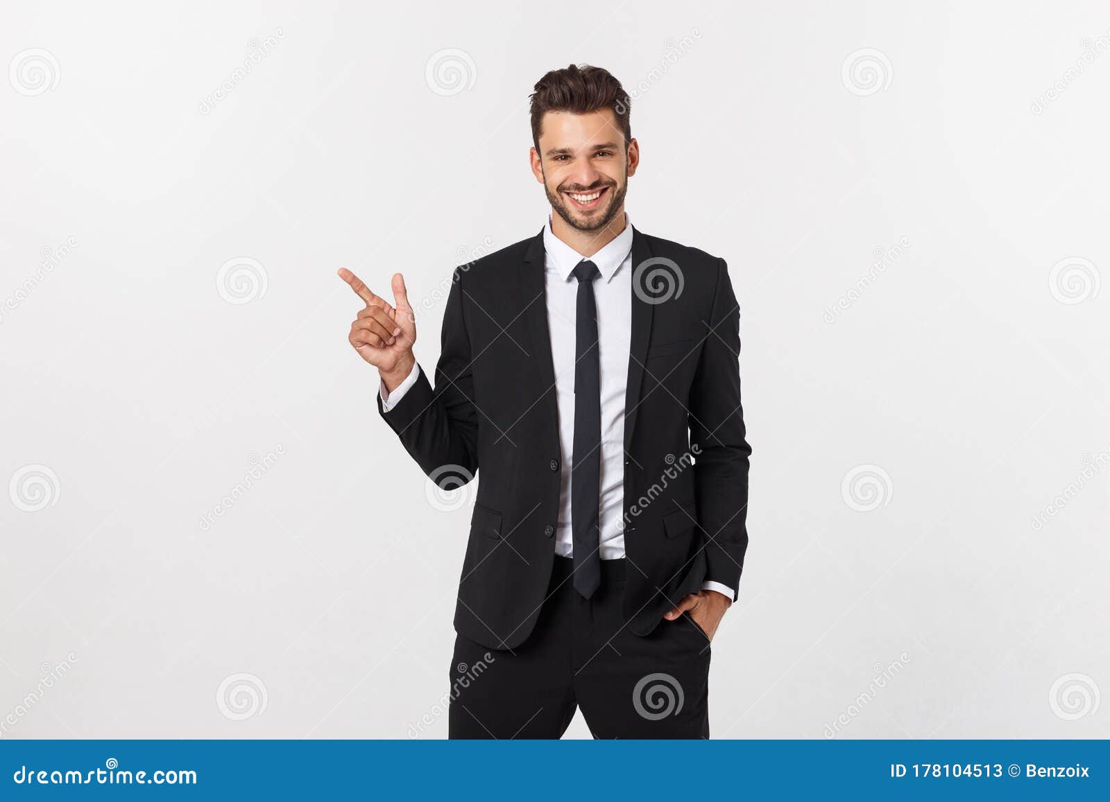 Portrait of Young Business Man in Suit Pointing at Copy Space Over ...