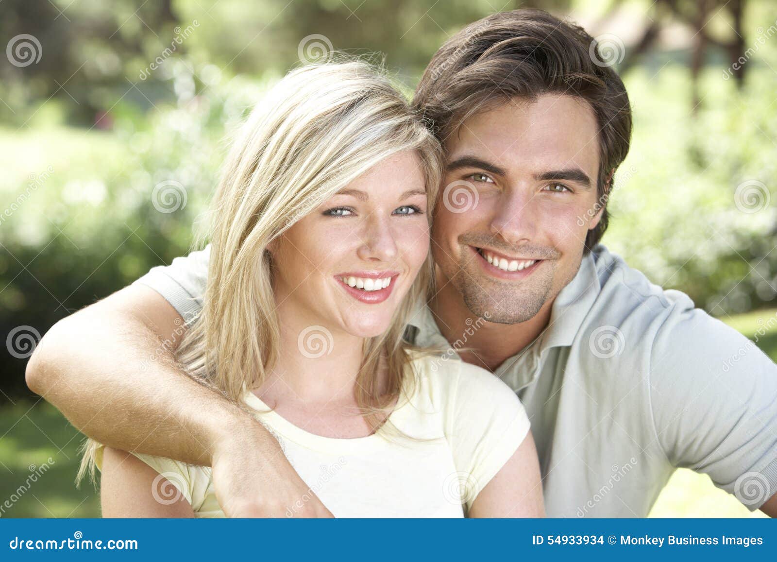 Portrait Of Young Couple Relaxing In Countryside Sto