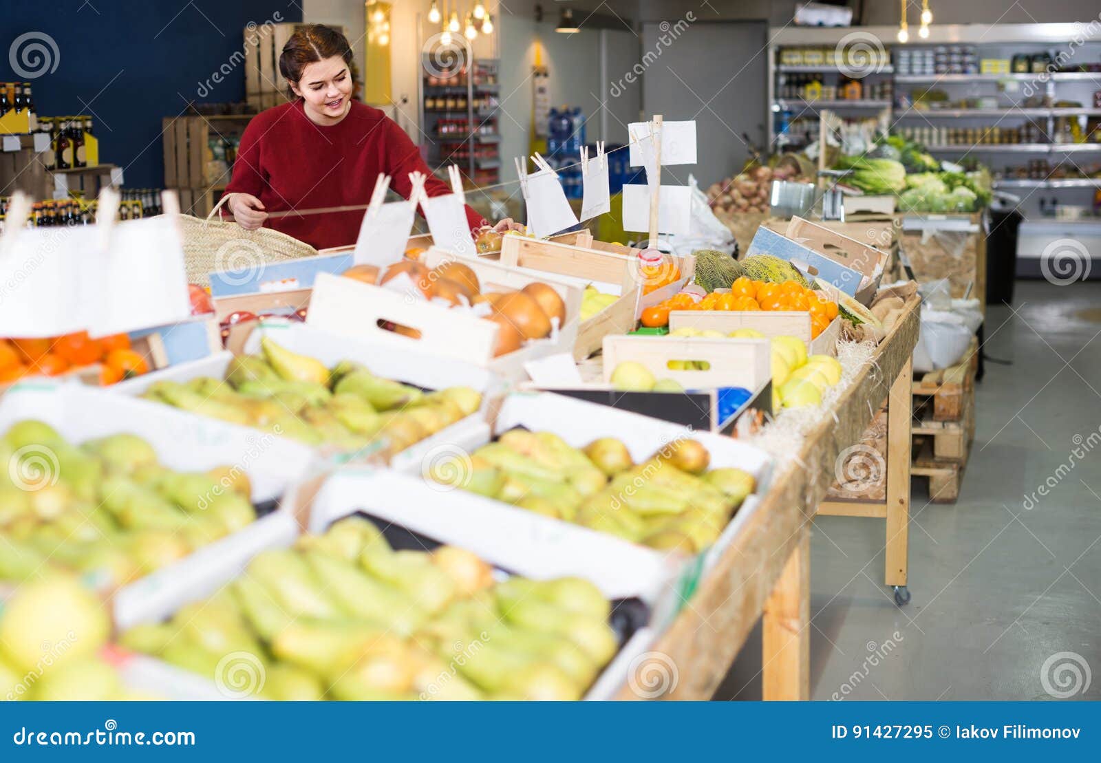 Portrait of Young Customer Selecting Apple in Grocery Stock Image