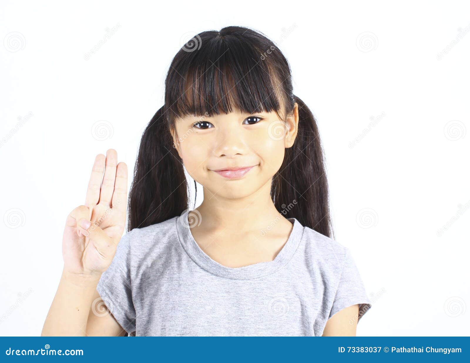 portrait of young cute girl posting with thtee fingers.