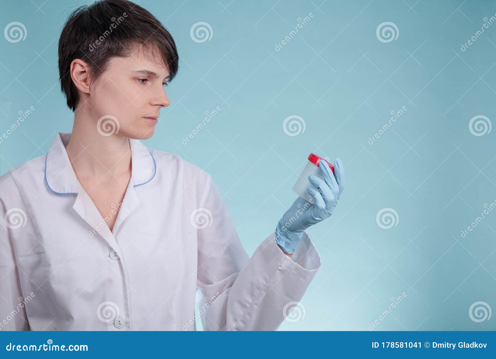Portrait Of A Young Doctors Girl Who Looks At Urine Tube As A Concept