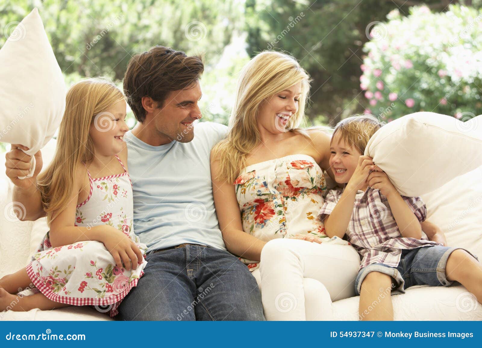 Portrait of Young Family Relaxing on Sofa Stock Image Image of