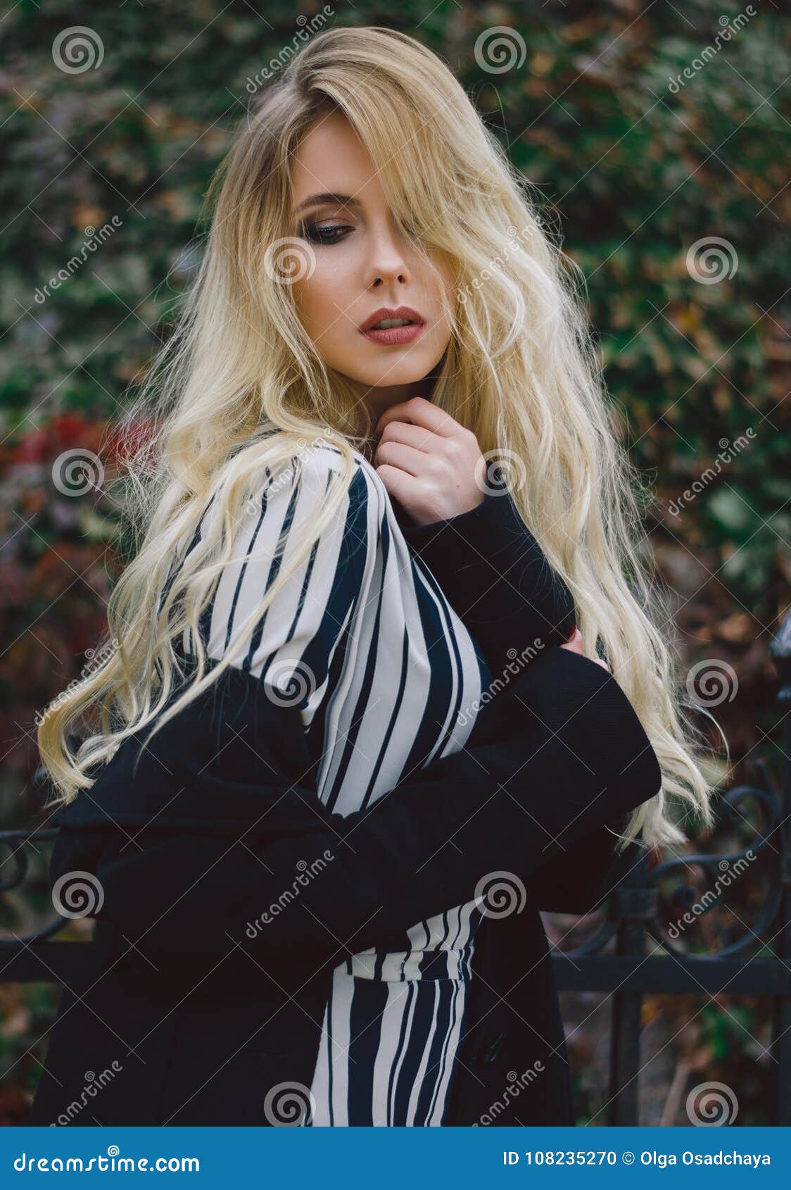 Portrait Of A Young Fashionable Blonde With Long Hair In A Black