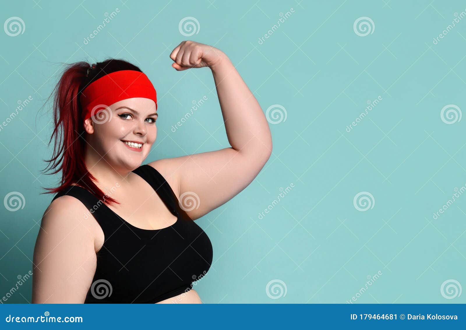 Portrait of a Young Fat Ginger Model in a Red Headband, Black Top. she ...