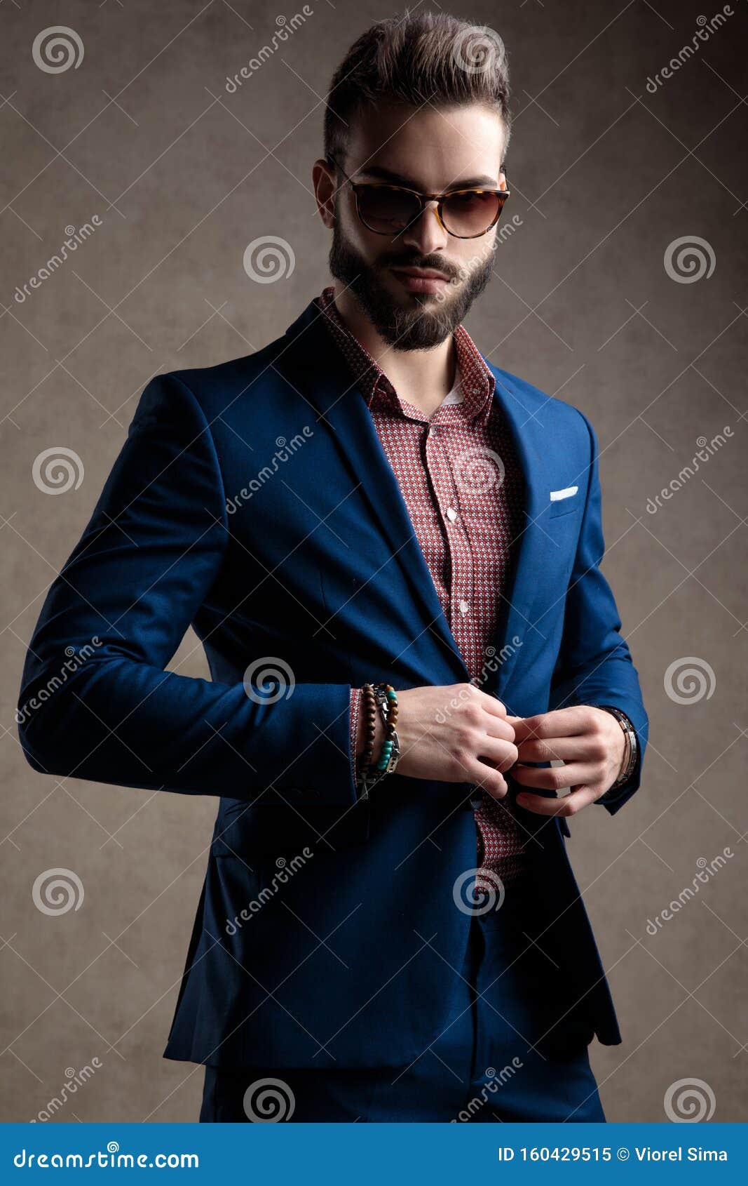businessman holding hands on his jacket`s button