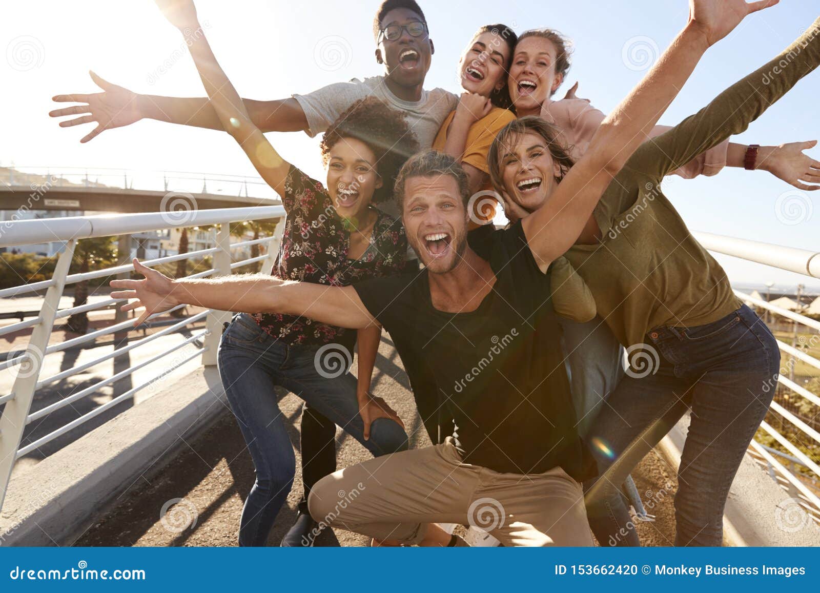 portrait of young friends outdoors posing on gangway together