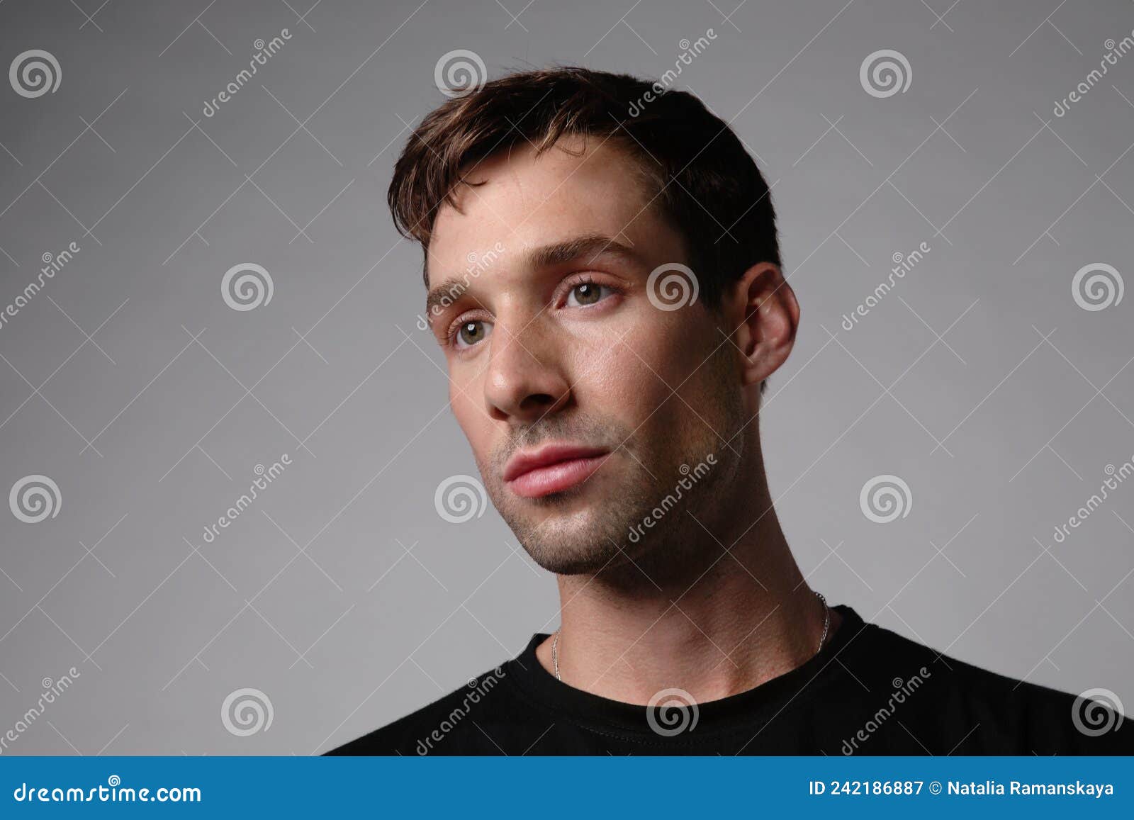 portrait of young handsome man with serious face expression. white background.