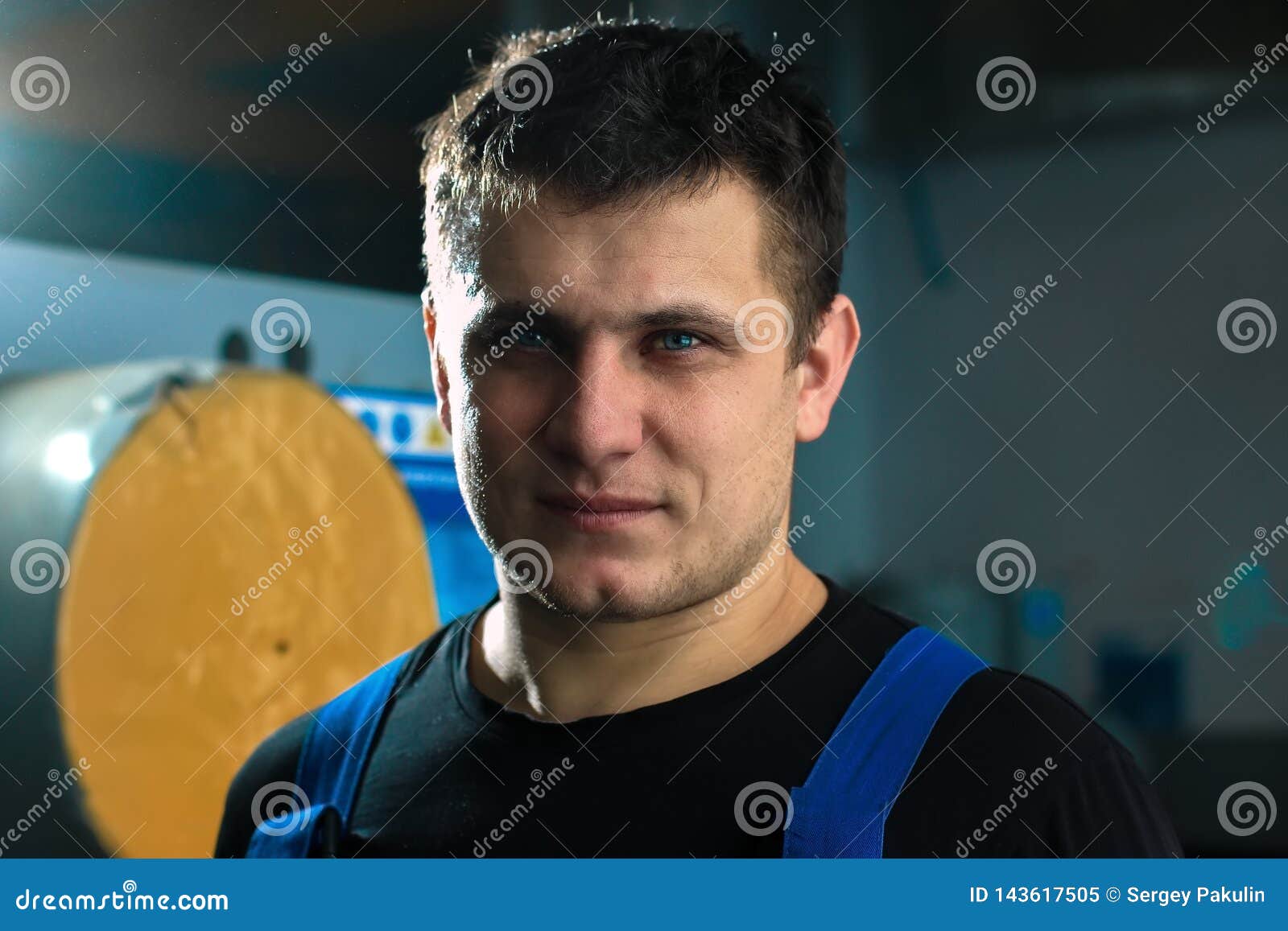 Portrait Of A Young Handsome Worker Of Caucasian Appearance. A Man With A Strongwilled Person