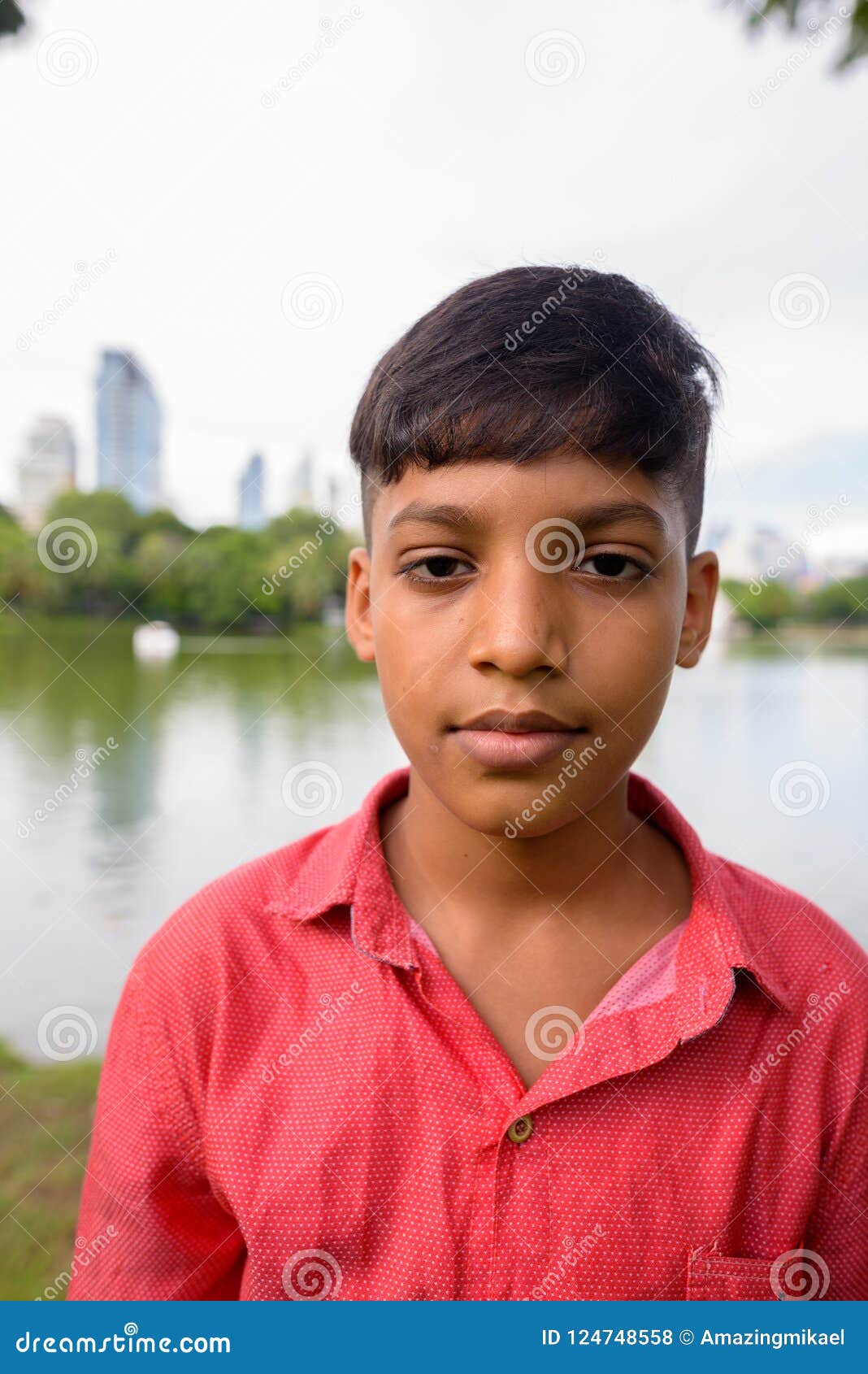 Portrait Of Young Indian Boy Relaxing At The Park Stock