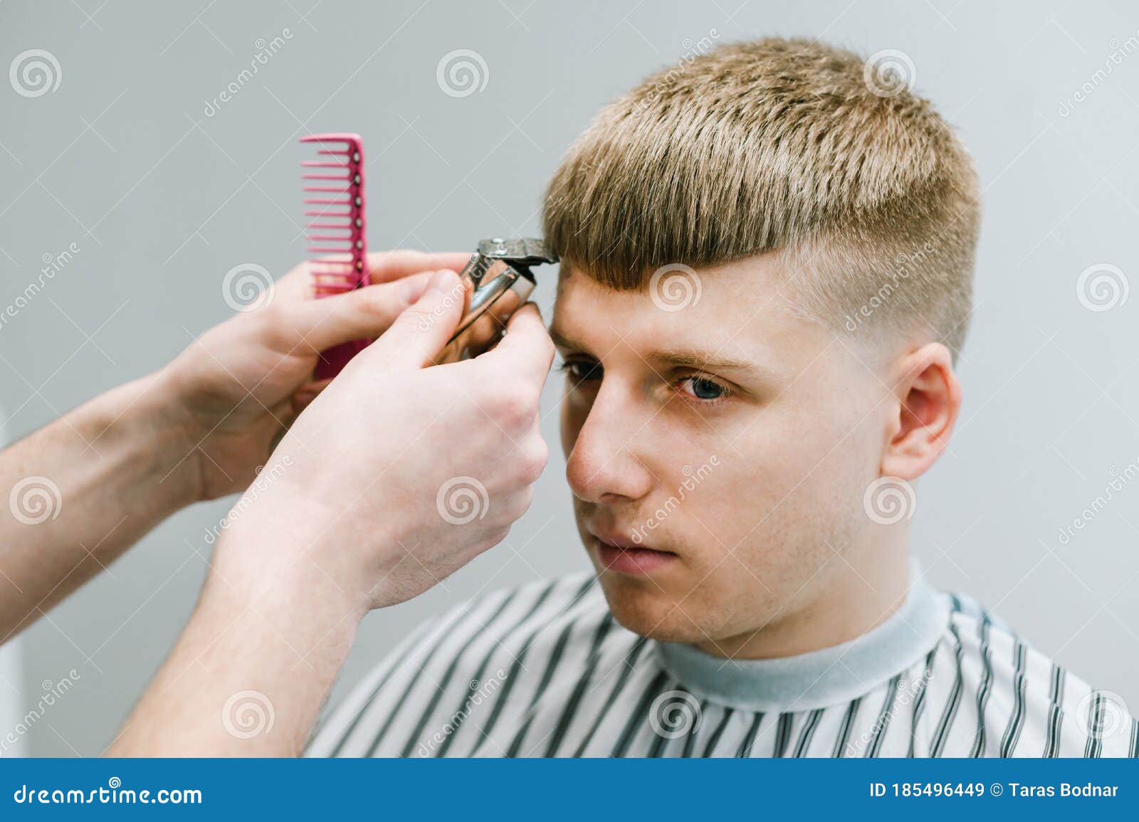Portrait of a Young Man Cutting Hair in a Barber Shop with a Serious  Face,close-up of a Hairdresser with a Trimmer Cut Client`s Stock Image -  Image of care, haircut: 185496449