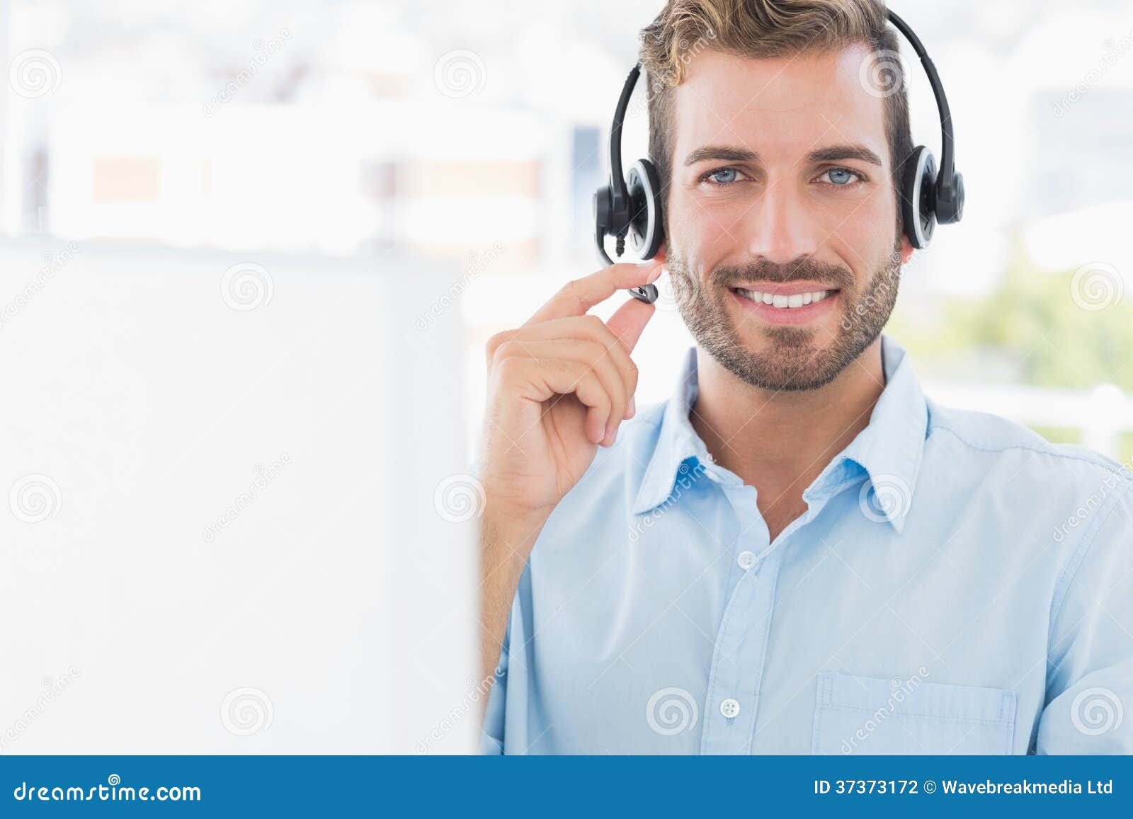 Portrait of a Young Man with Headset Using Computer Stock Photo Image