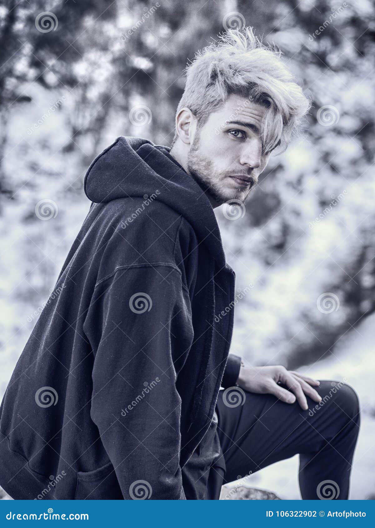 portrait young man hoodie posing outdoor winter setting snow all around looking camera handsome man snow 106322902