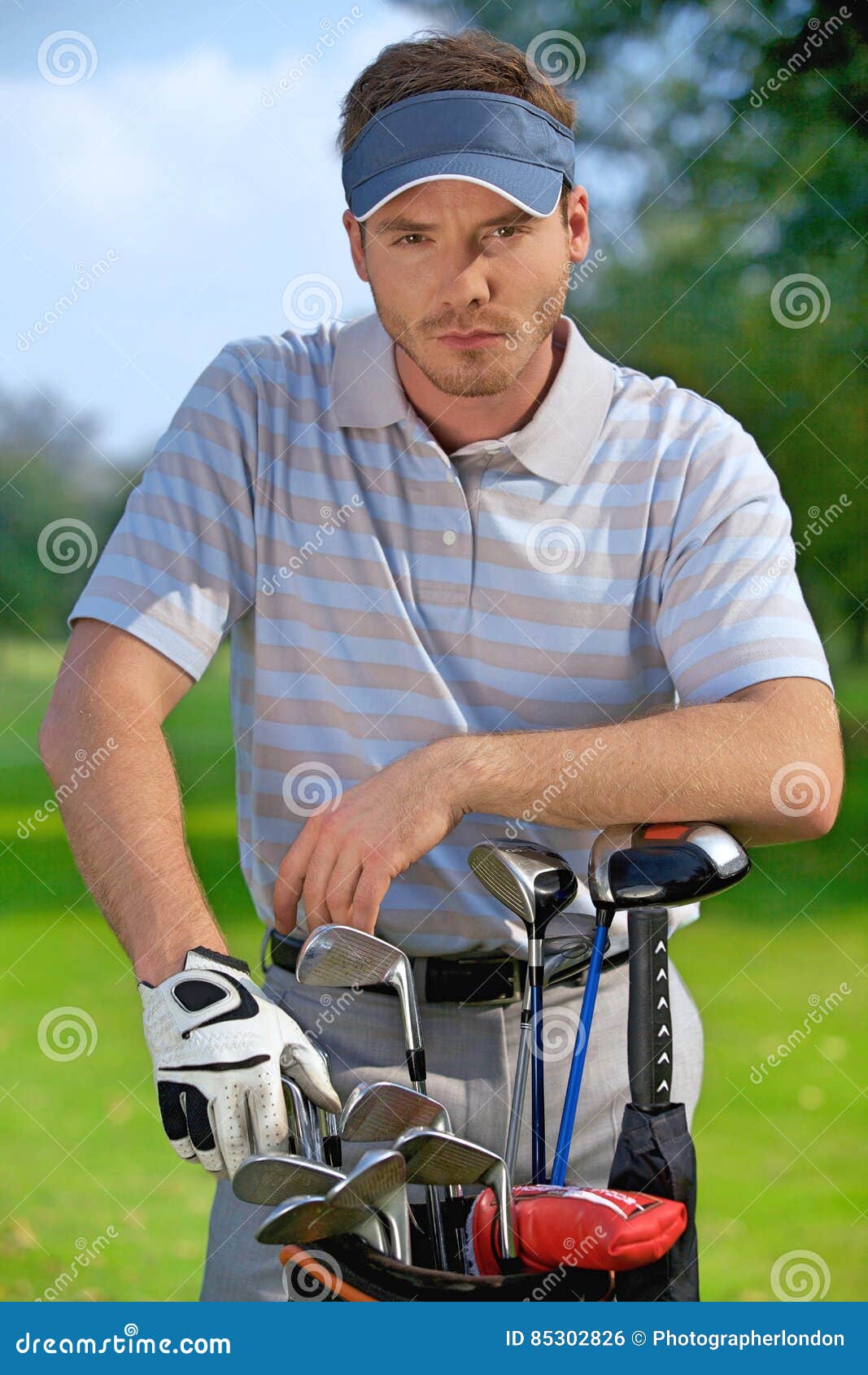 Portrait of Young Man Standing by Golf Bag Full of Sticks Stock Photo ...