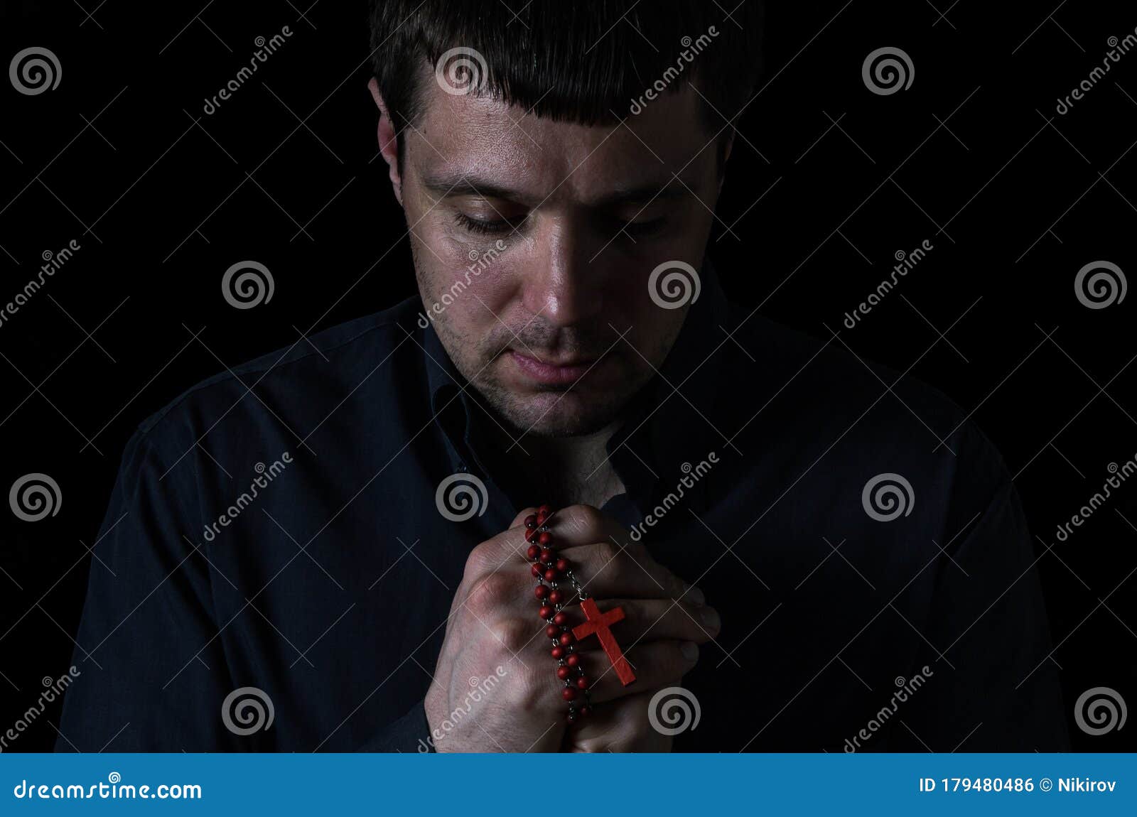 Portrait of a Young Man Who Praying with Prayer Beads with a Crucifix ...