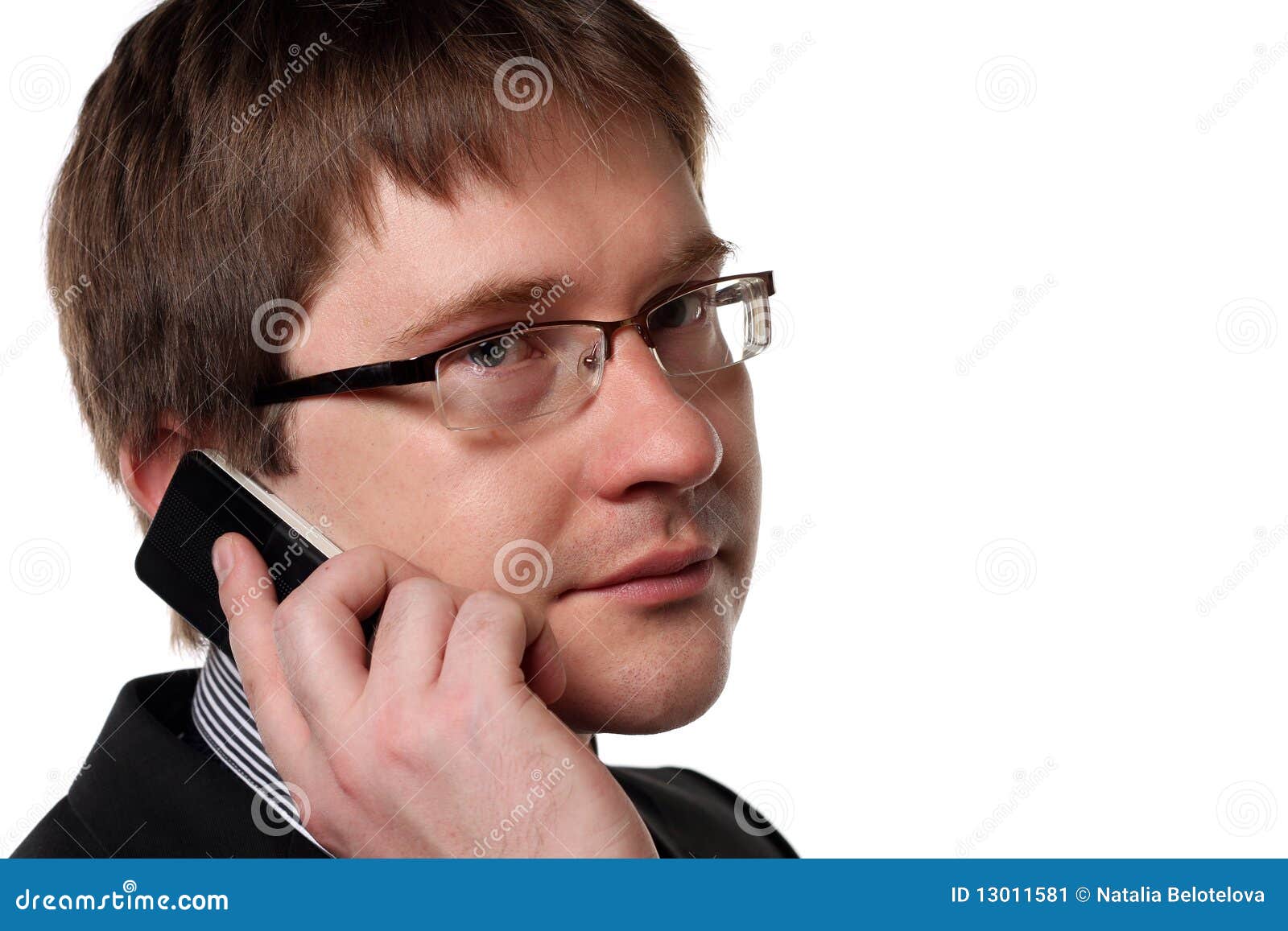  A man with short brown hair and glasses is talking on the phone.