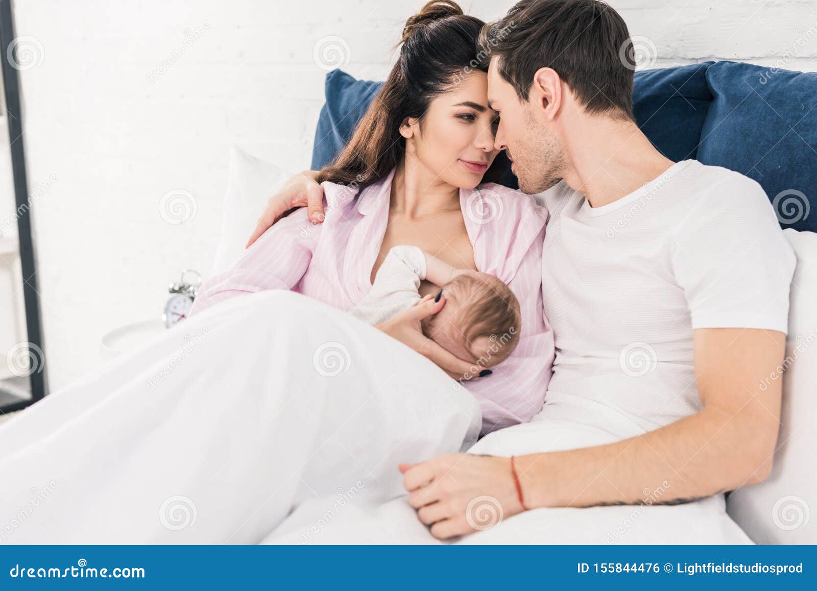 Woman Breastfeeding Husband Stock Photos image