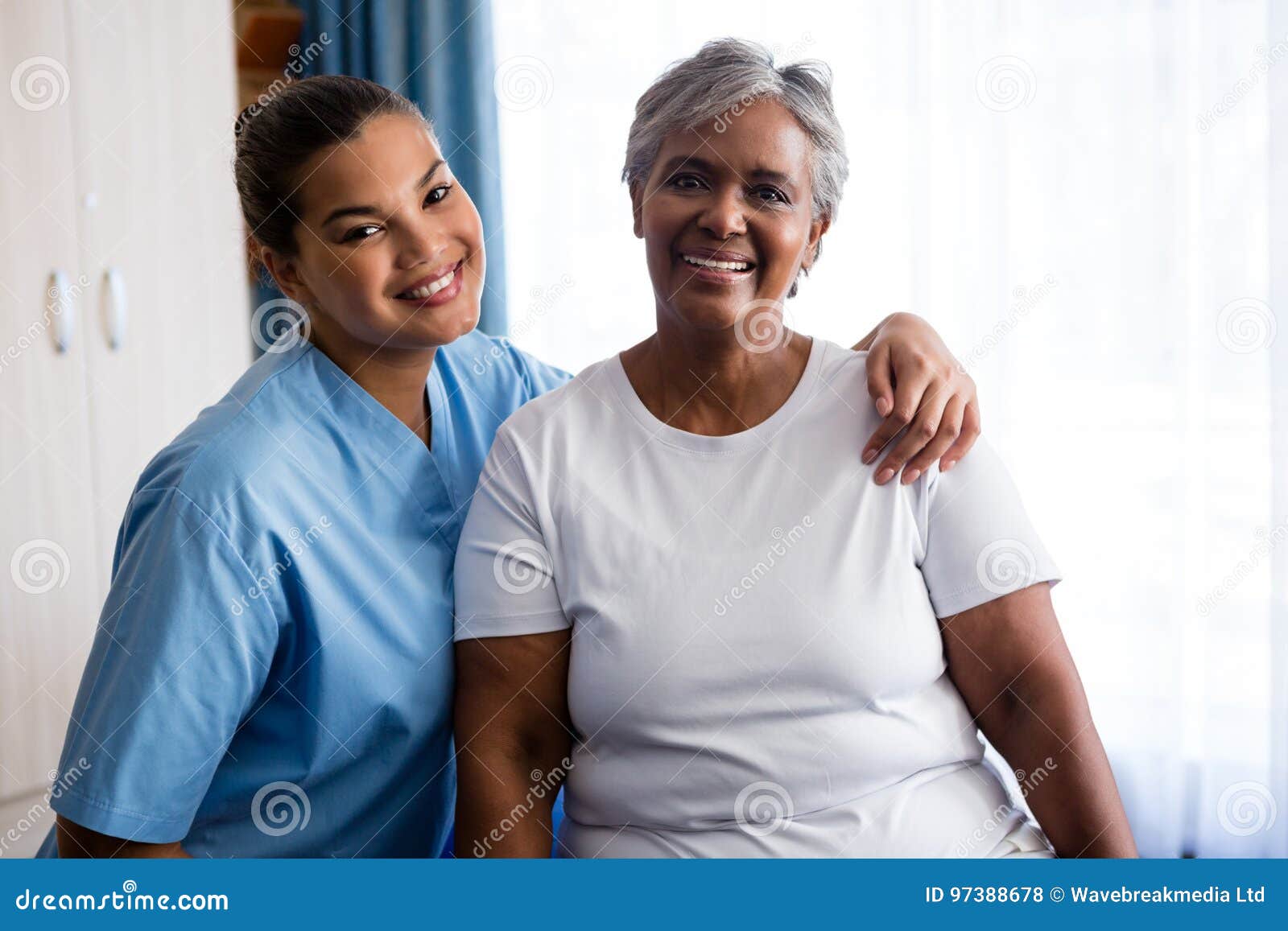 portrait of young nurse with patient in nursing home