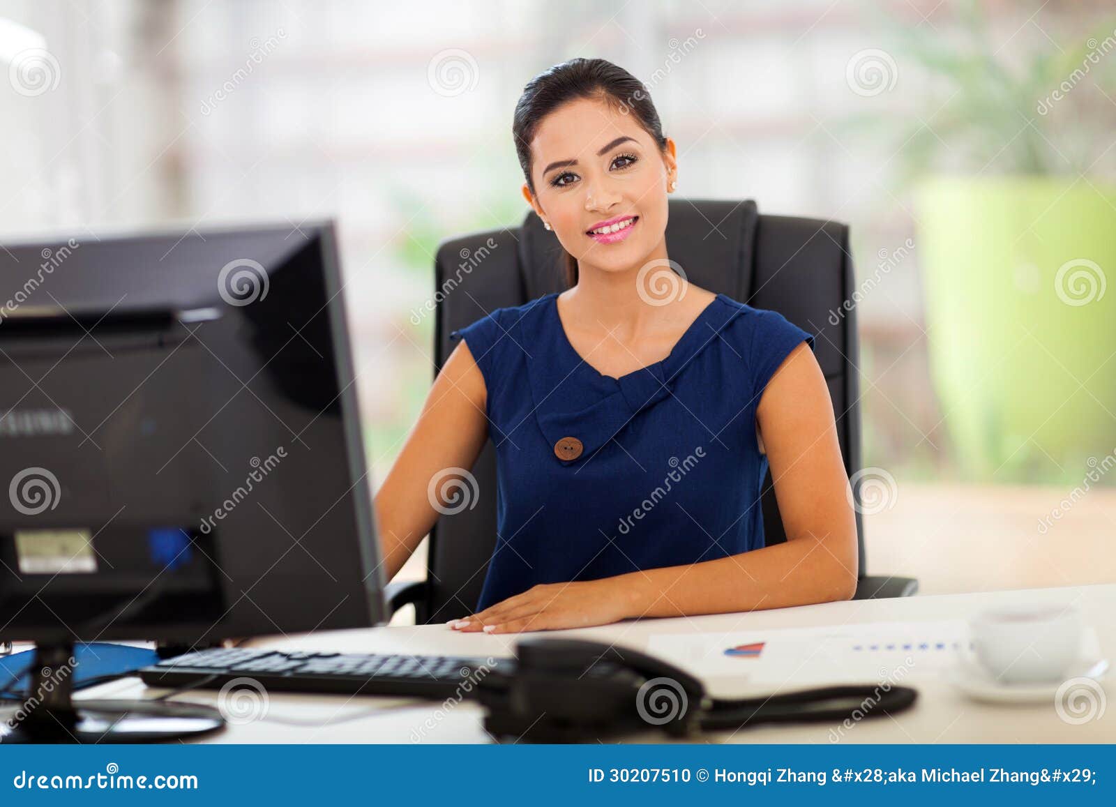 Portrait of young office manager in her modern office.