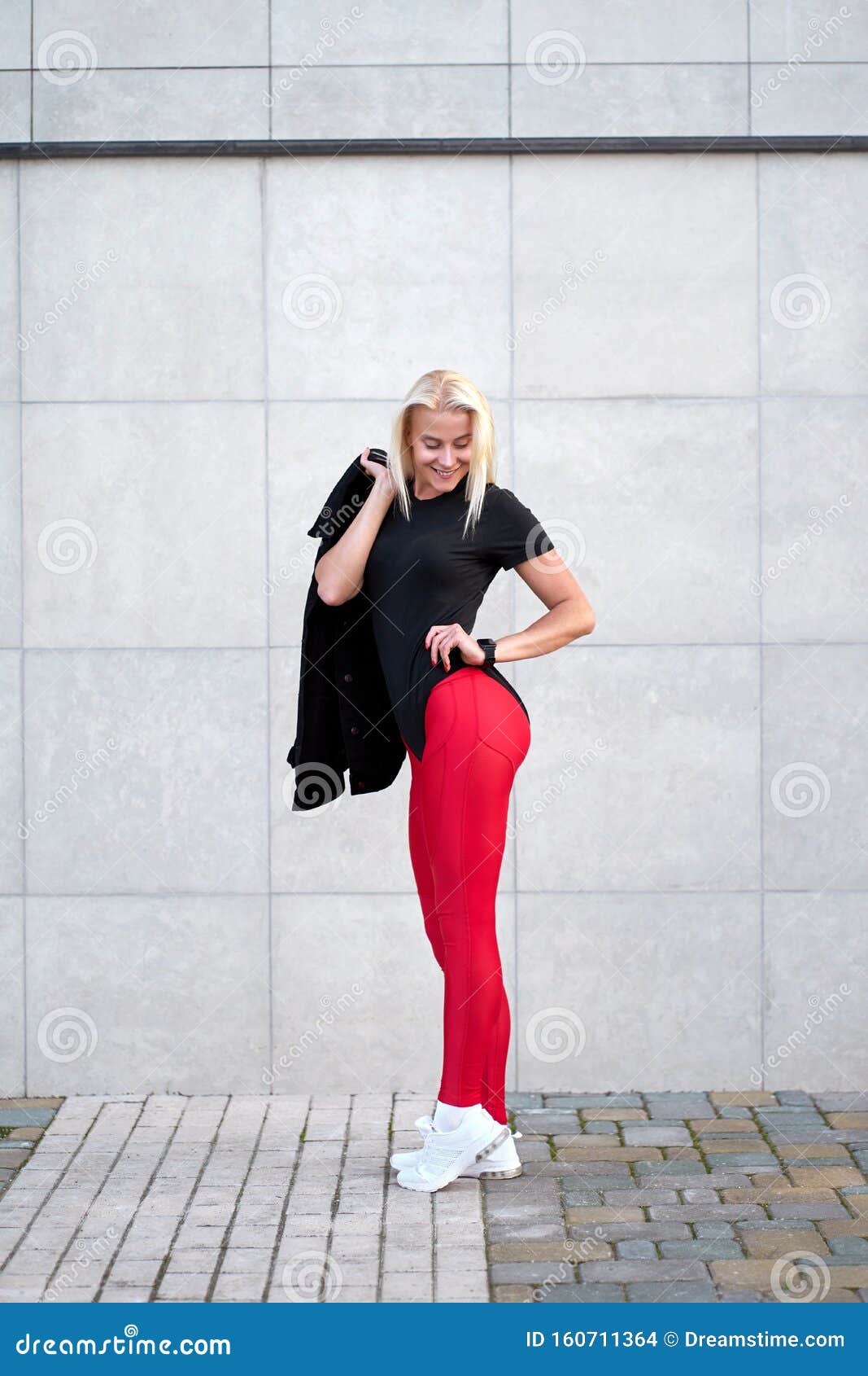 Portrait of Young Positive Sporty Woman Wearing Black Sportswear, Red  Leggings and Trendy White Sneakers. Outdoor Shot on Grey Stock Photo -  Image of feminine, shape: 160711364