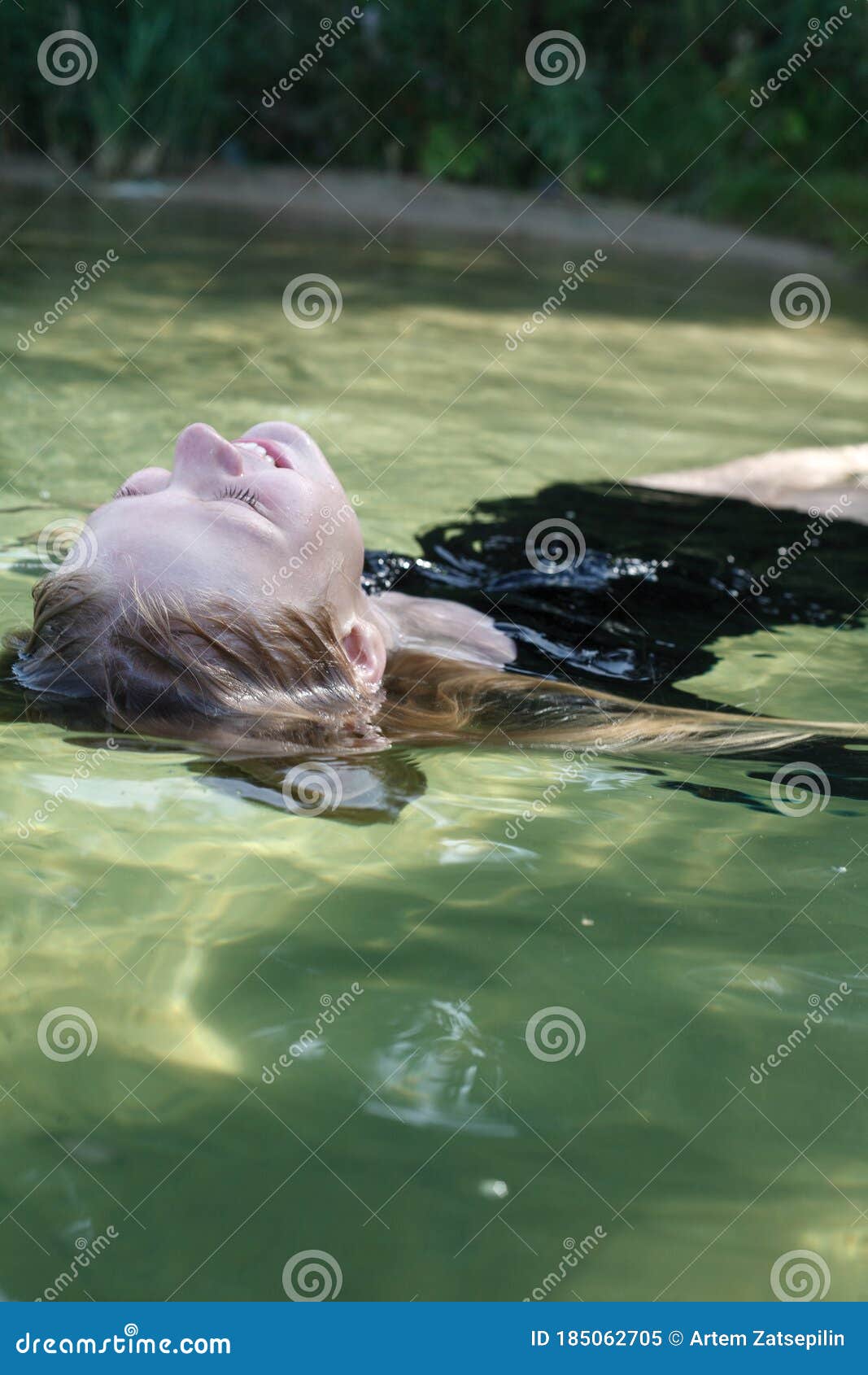 Portrait of Young Pretty Caucasian Blond Girl in Black Dress Swiming in ...