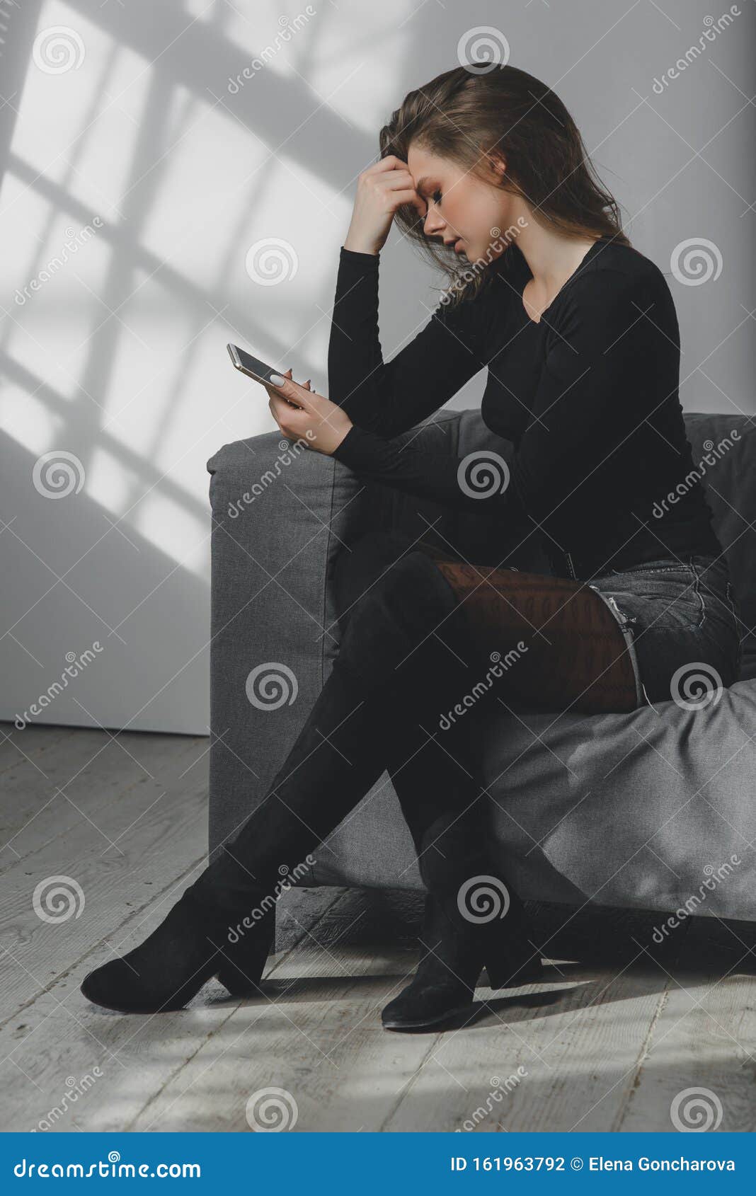 Portrait of a Young Sad Crying Girl with a Smartphone in Her Hand ...