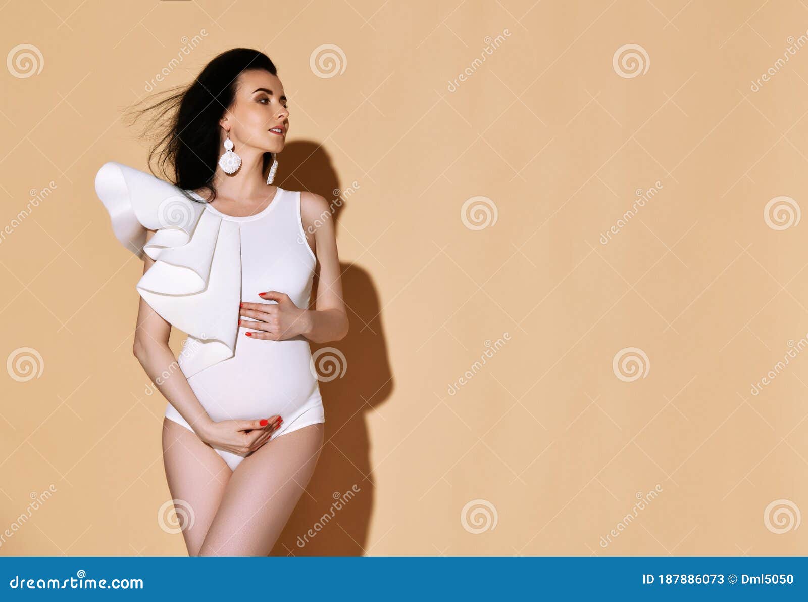 Portrait of Young Sensual Pregnant Woman in White Bodysuit Standing,  Embracing Belly and Looking Aside at Copy Space Stock Image - Image of  mother, earrings: 187886073
