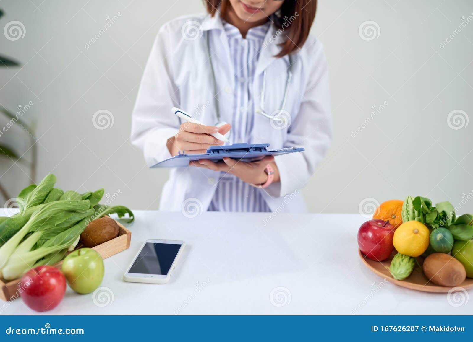 portrait of young smiling female nutritionist in the consultation room. dietitian working on diet plan